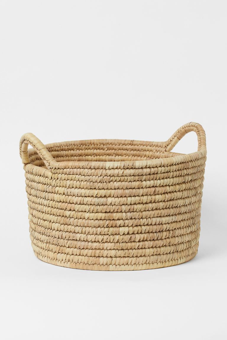 Large, shallow storage basket in braided straw with two handles at top. Height 10 1/4 in., diamet... | H&M (US + CA)