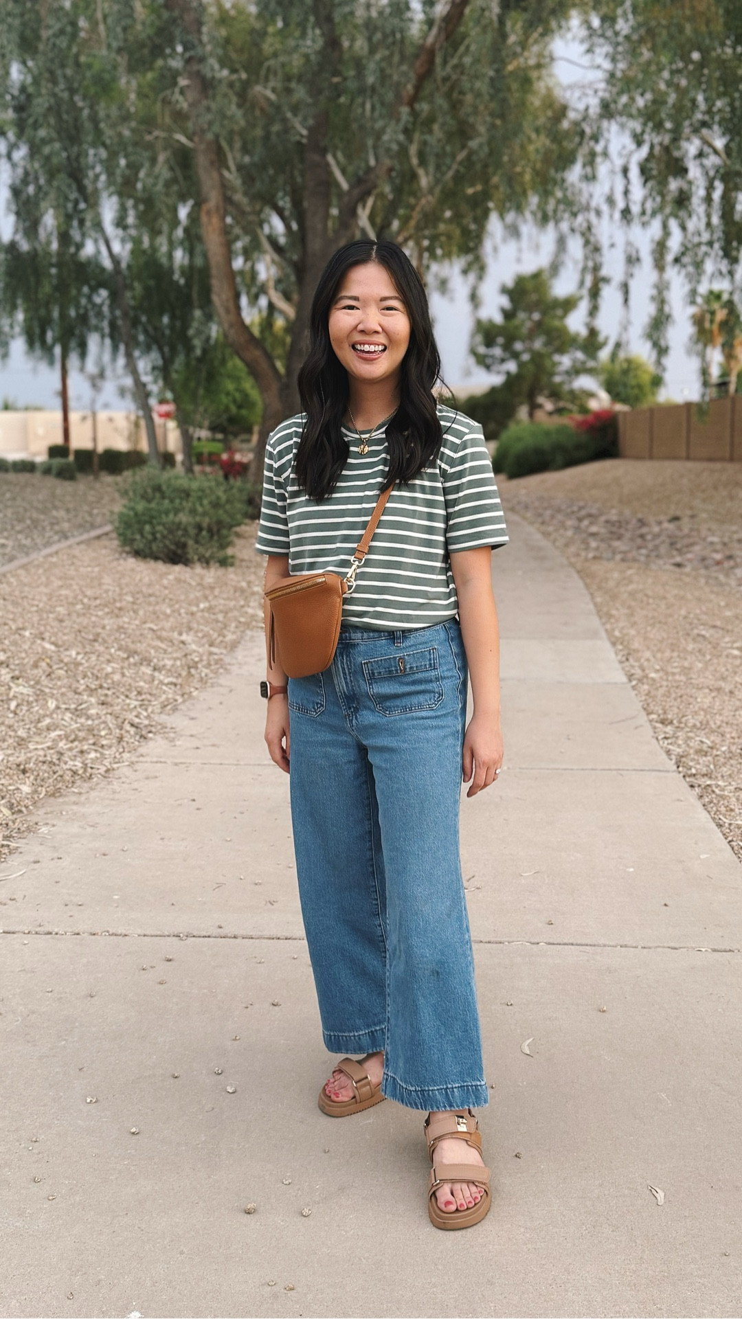 This is my go to casual mom outfit whether I’m running errands or chasing my kids. My green and white striped T-shirt is incredibly soft and these high waisted wide leg jeans are the perfect fit. You can usually find me wearing my brown leather sling bag. Stray platform sandals are old, but I linked very similar style styles.

Striped shirt: S
Jeans: 27P

#LTKootd #LTKmomlife #LTKKids
