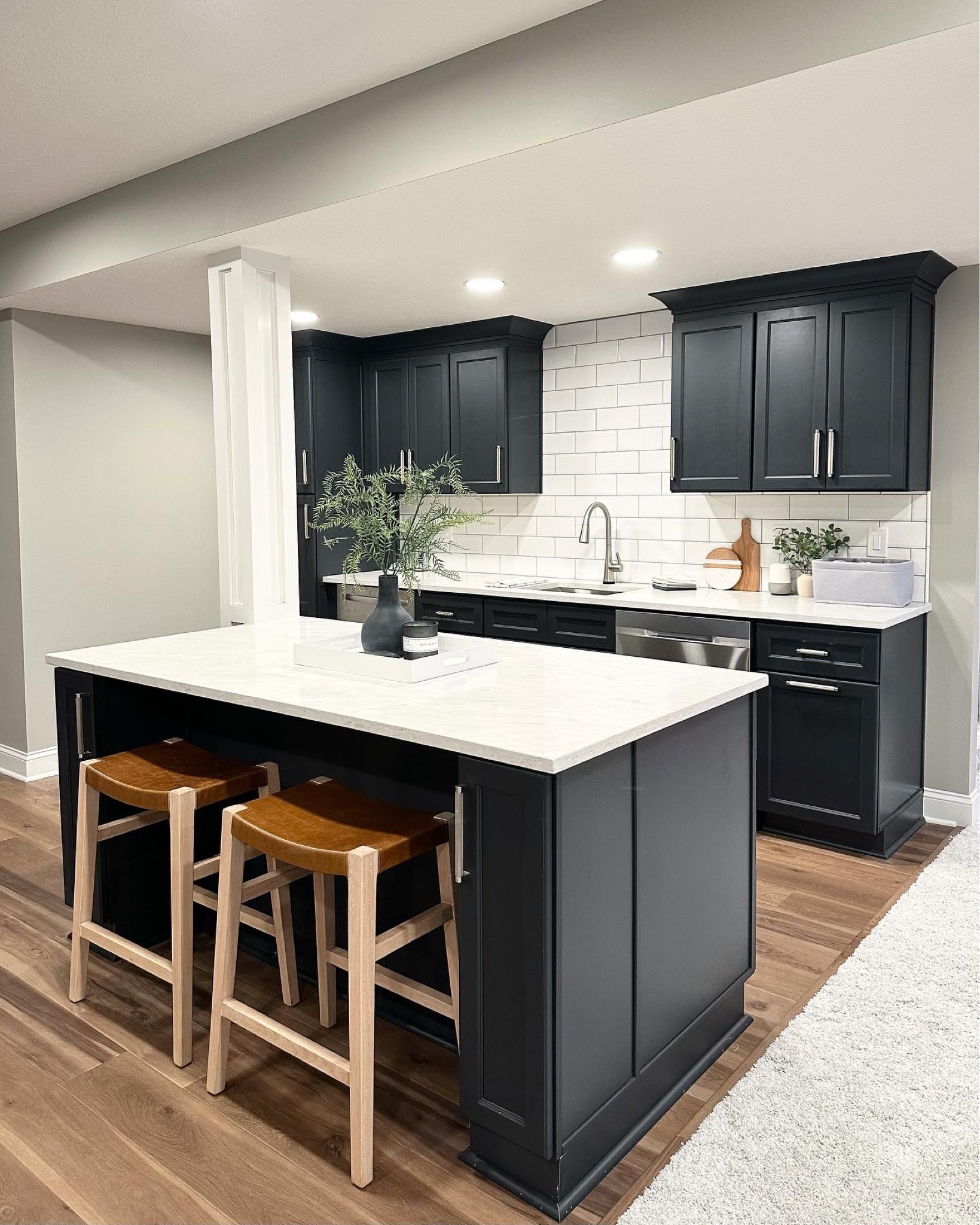 This gorgeous basement bar includes charcoal cabinetry, brushed nickel knurled hardware, cognac counter stools, marble counters, and hardwoods! This was such a fun project.

#LTKFind #LTKhome #LTKstyletip