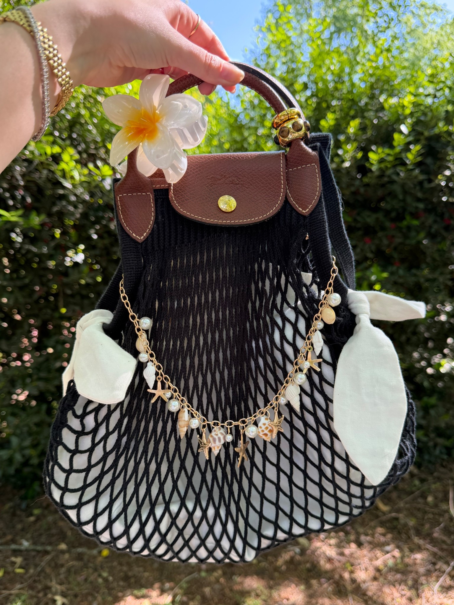 Bag of the day 🐚☀️
Longchamp Le Pliage Le filet 
Seashell and pearl bag chain
Longchamp Le filet net bag insert
Tropical floral claw clip
Bag rings from Madewell


#LTKootd #LTKdayinmylife