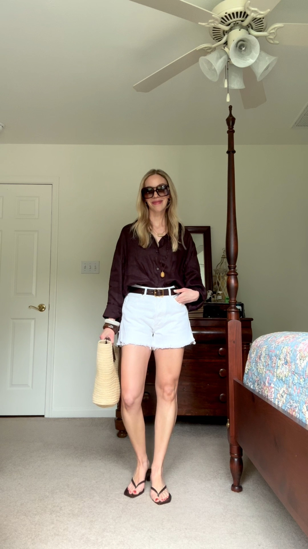 Casual summer outfit with dark brown linen shirt, white cutoff denim shorts, beaded pendant necklace, kitten heel thong sandals, Le Tanneur straw tote

#LTKootd #LTKgrwm #LTKSeasonal