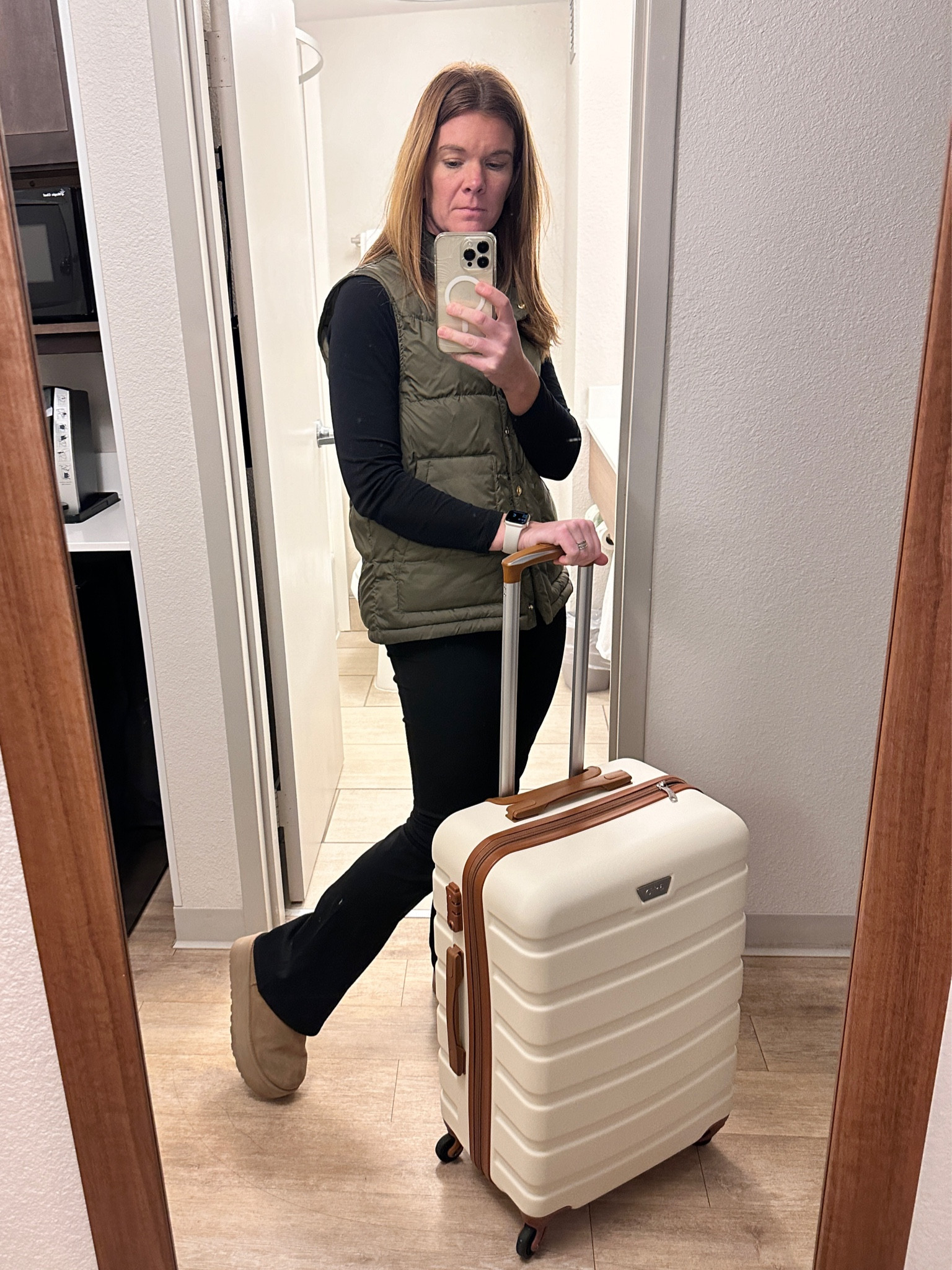 Cozy winter travel outfit.  Tissue turtleneck, black flare leggings from Amazon, platform uggs, and a cozy green down vest from tuckernuck.  I also love this luggage. Comes in a set of three and this is the medium size 💙

#LTKstyletip #LTKtravel