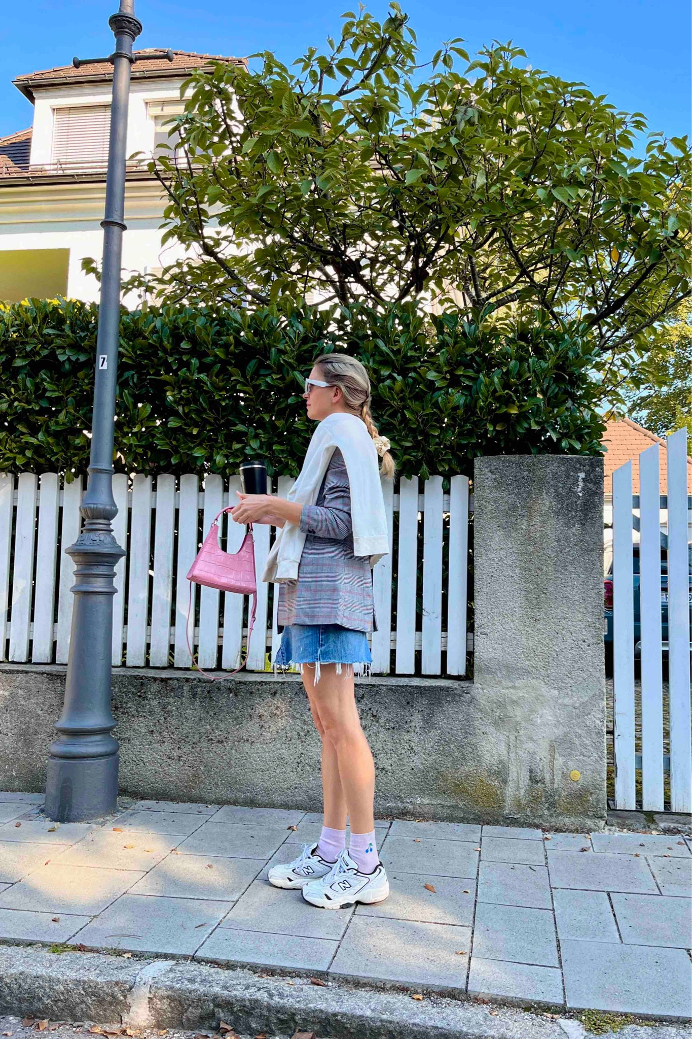 Plaid Blazer. Fashion Blogger Girl by Style Blog Heartfelt Hunt. Girl with blond hair wearing a plaid blazer, pink T-shirt, white cat-eye sunglasses, denim skirt, pink Staud bag, pink socks and New Balance sneakers. #plaidblazer #denimskirt #pinklook #scrunchiestyle #colorfuloutfit #colorfulstyle #colorfulfashion #colorfullooks #fashionfun #cutefalloutfit #fallfashion2023 #falllookbook #fitcheck #dailylooks #dailylookbook #contentcreator #microinfluencer #discoverunder20k