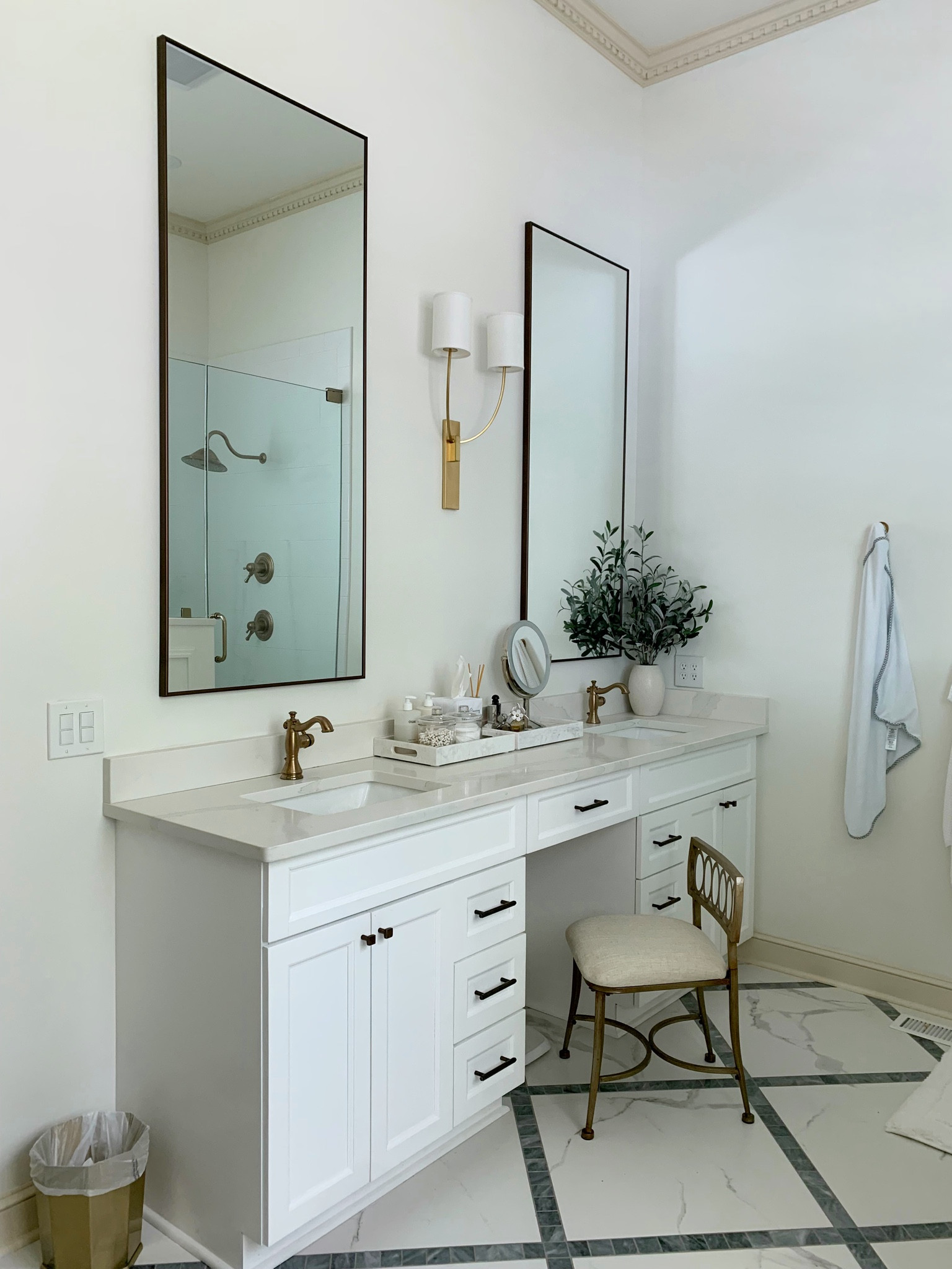 Primary bathroom details 🛁 | gold vanity stool | white marble tray | makeup mirror | Delta champagne bronze sink faucet | tall vanity mirrors | floor/wall mirrors | double gold sconce light | white bathroom 

#LTKhome