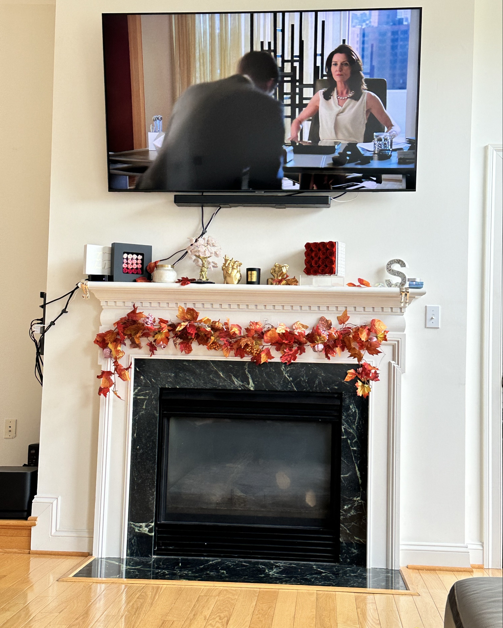 Hey! I just saw this beautiful garland made of autumn leaves, draped over a fireplace mantle. The leaves are in stunning shades of red, orange, yellow, and brown, with some having a shiny, metallic look that adds a nice sparkle. It really creates a cozy, seasonal vibe in the room!

#LTKFamily #LTKHome