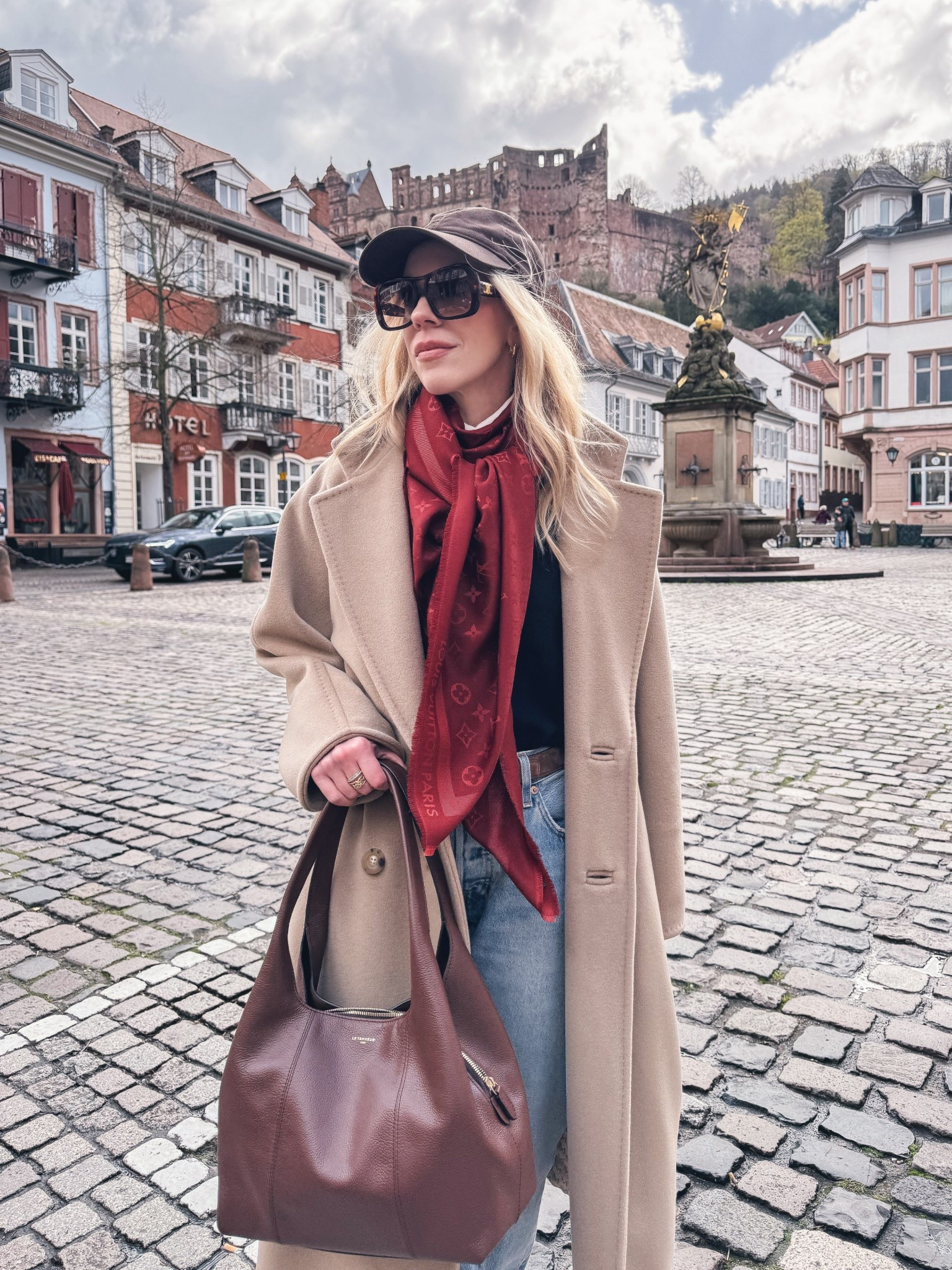 European vacation style, @Zara brown baseball cap, red Louis Vuitton scarf, camel coat, navy and red, Le Tanneur dark brown spring handbag 

#LTKOver40 #LTKTravel #LTKSeasonal