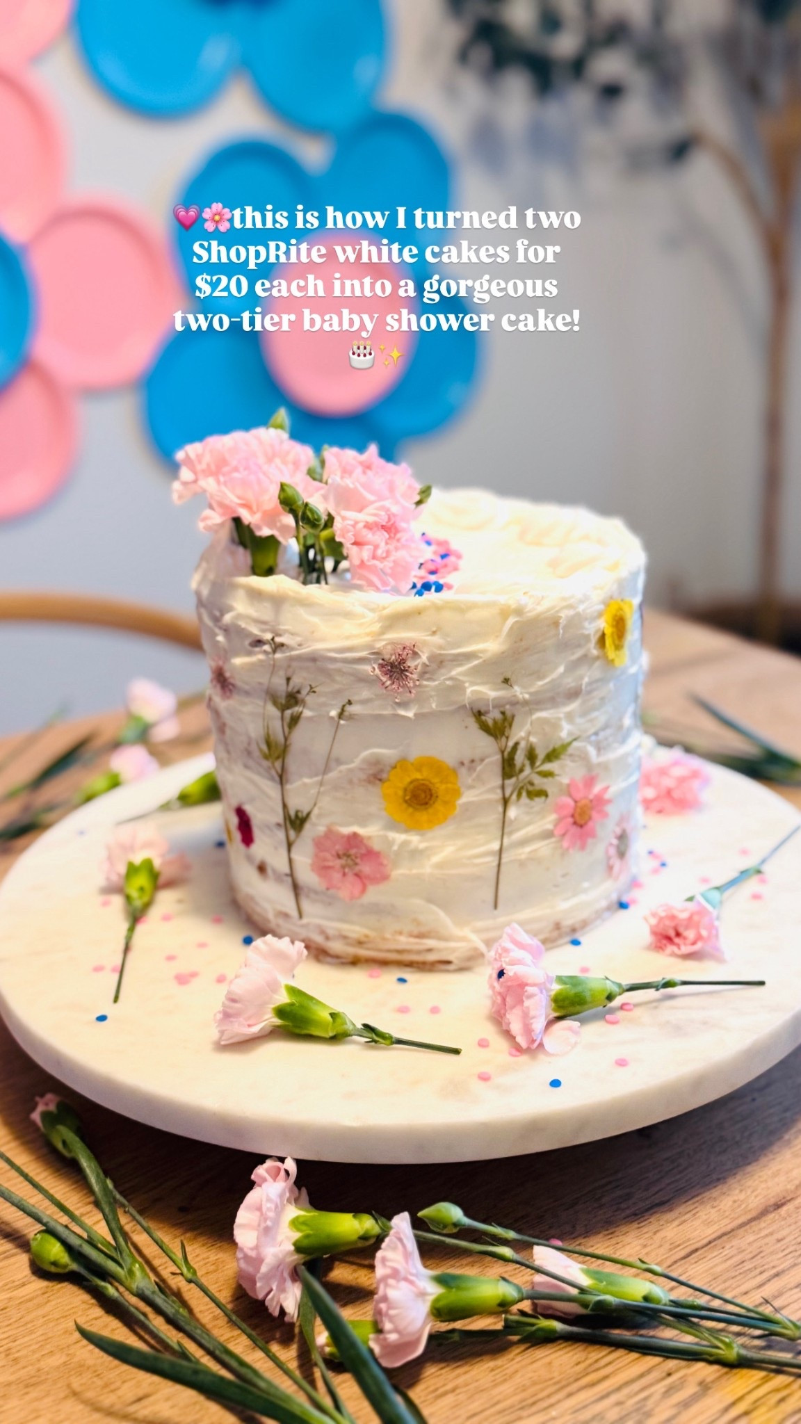 Turned two simple white cakes from @shopritestores for $20 each into a beautiful two-tier baby shower cake!🎂💖

I stacked the cakes on top of each other and covered them with whipped cream to make them look all white. Then, I added pretty spring edible flowers around the sides and placed lovely pink roses at the corner, using foil paper to keep them clean. 🌸✨ To finish it off, I sprinkled pink and blue sprinkles on top and added some flowers on the side to match our baby shower theme. 🌼💙💗

Making this cake was so much fun and perfect for celebrating! 🥳

#BabyShowerCake #DIYDesserts #Hosting #SweetTreat 

#LTKfoodie #LTKHome