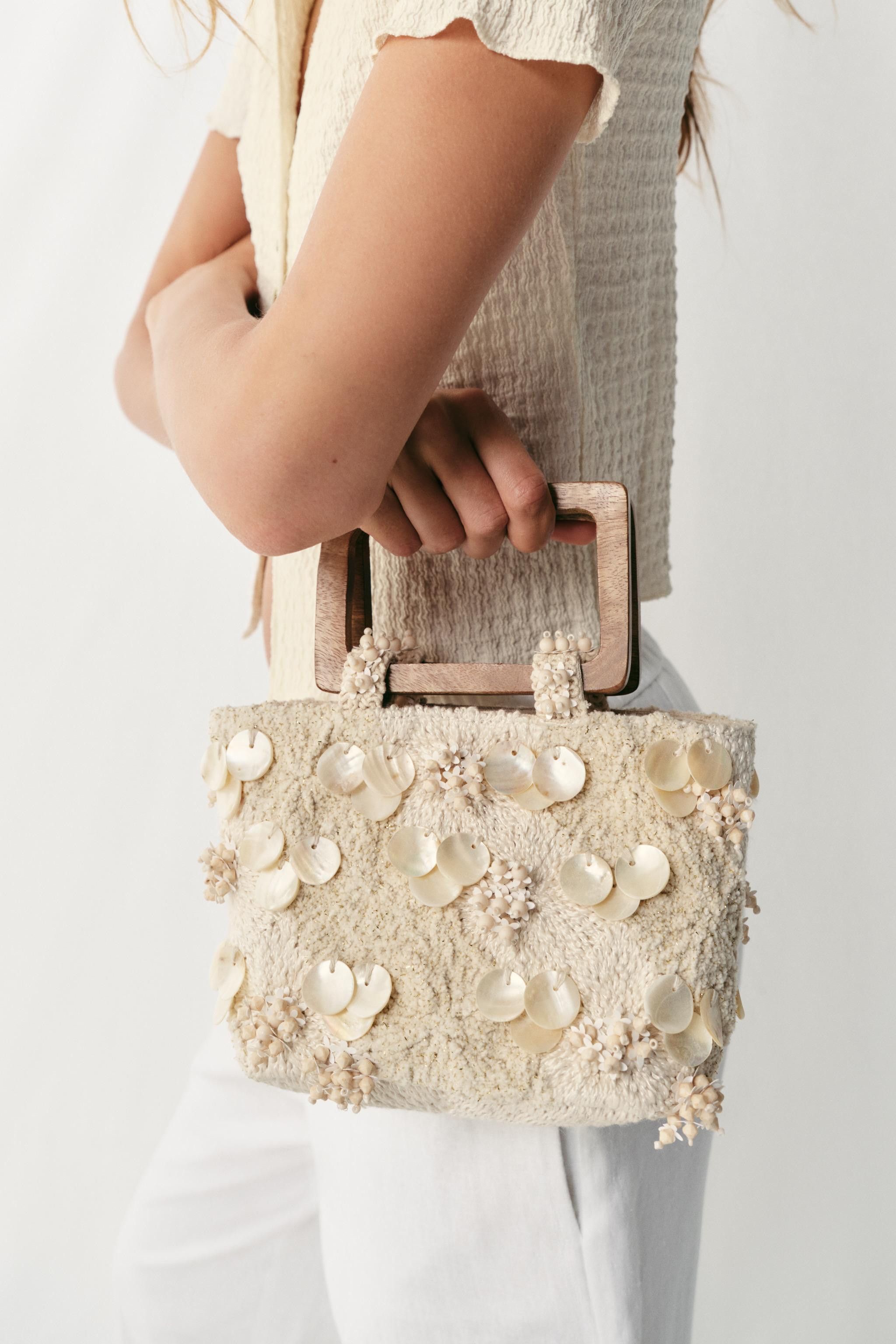 Mini handbag in fabric. Appliqu\u00e9 and embroidered details on the body. Double rigid handle in... | Zara US