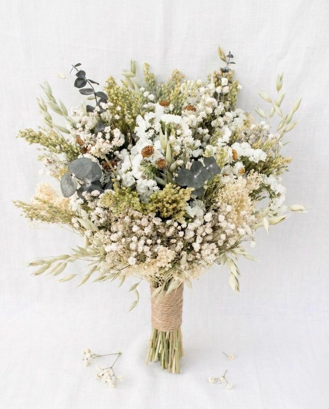 This soft neutral dried flower bouquet is filled with white statice, baby’s breath, canary grass, Aveena oats, and eucalyptus for a naturally elegant look. Perfect for weddings, birthdays, Mother’s Day, anniversaries, or adding everlasting beauty to your home décor. Available in multiple sizes and finished with your choice of twine, burlap lace, or ivory ribbon for a personalized touch. #DriedFlowerBouquet #NeutralDecor #BridalBouquet #PreservedFlowers #MothersDayGift #WeddingFlowers #BohoWedding #EverlastingFlowers #LTKHome #FloralInspiration

#LTKWedding #LTKHome #LTKSeasonal