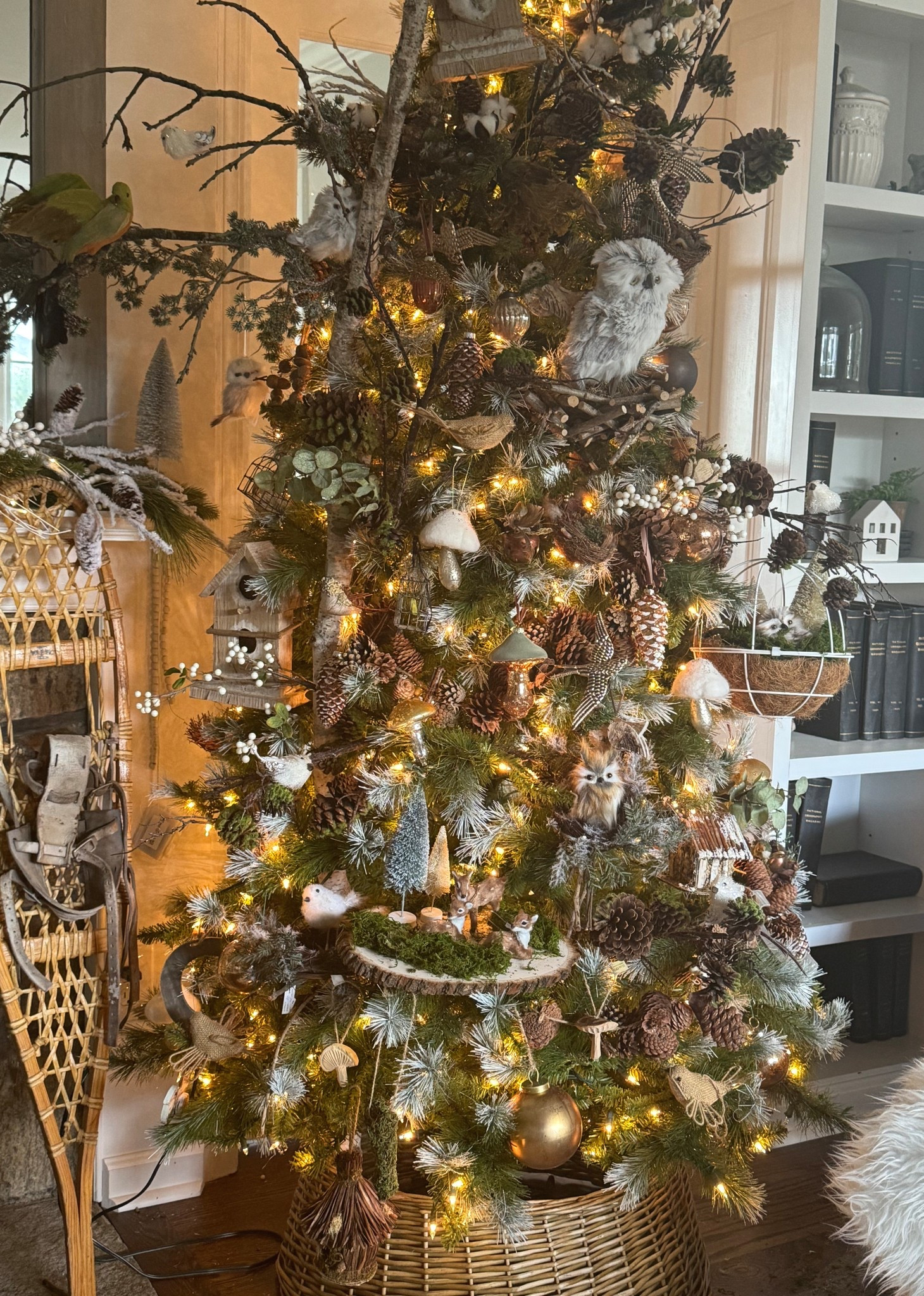 Bring the beauty of the forest indoors with this woodland Christmas tree idea — filled with pinecones, owls, birch branches, and twinkling lights. This rustic Christmas décor style blends cozy cottage charm with natural textures, perfect for your holiday home decorating. Layer in neutral ornaments, birdhouses, and forest accents for a magical, nature-inspired Christmas tree design that feels timeless and elegant.