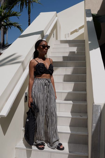 Vacation outfit inspo: black and white stripe pants, oversized floral top 

#LTKtravel #LTKstyletip