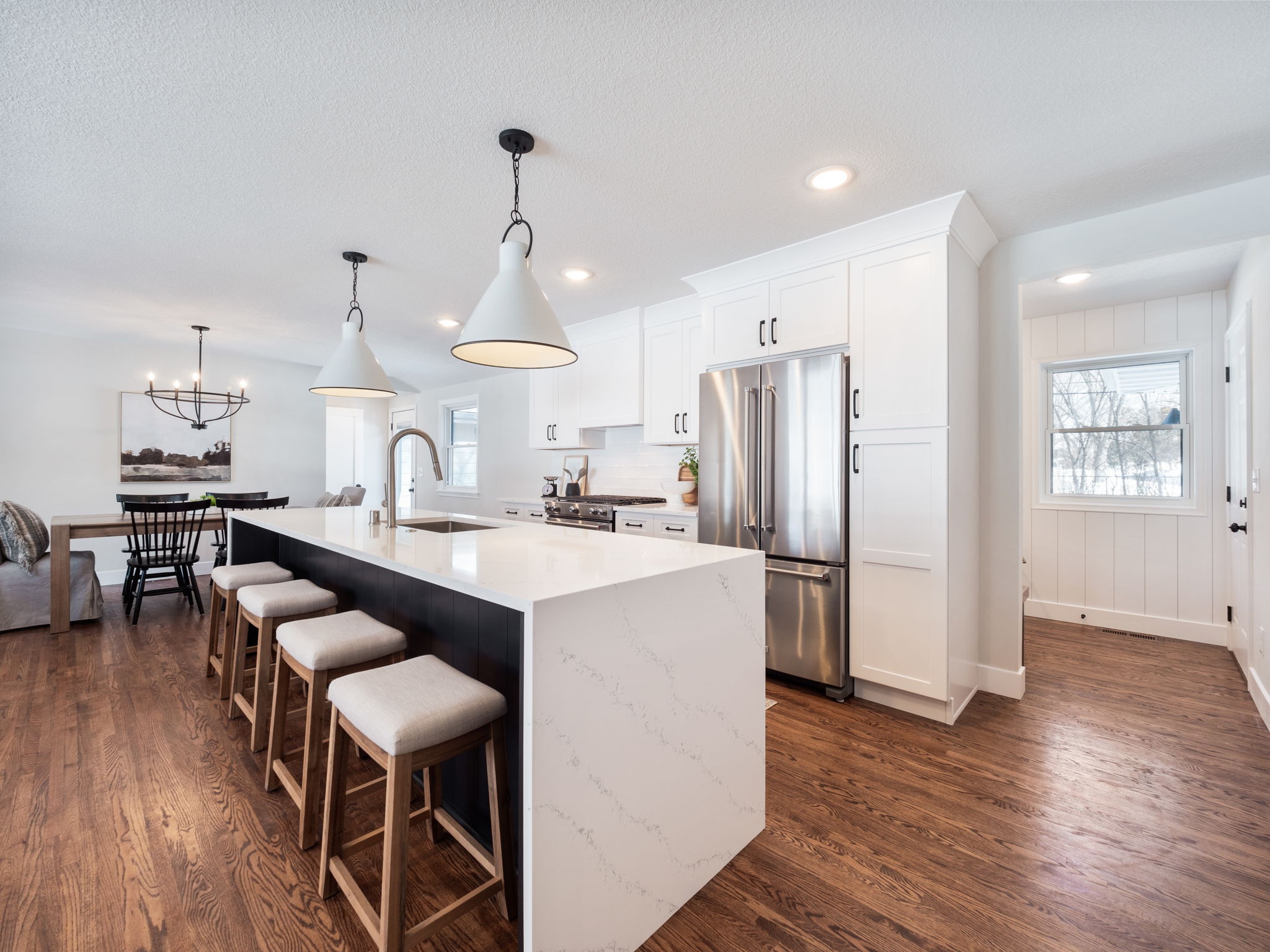 Choosing lighting in an open layout can be easy.  Pairing black and white metal fixtures with the right scale complement the overall design.  Pro tip - metal shades on the island pendants are easy to clean and are always smudge free. 

#LTKFind #LTKstyletip #LTKhome