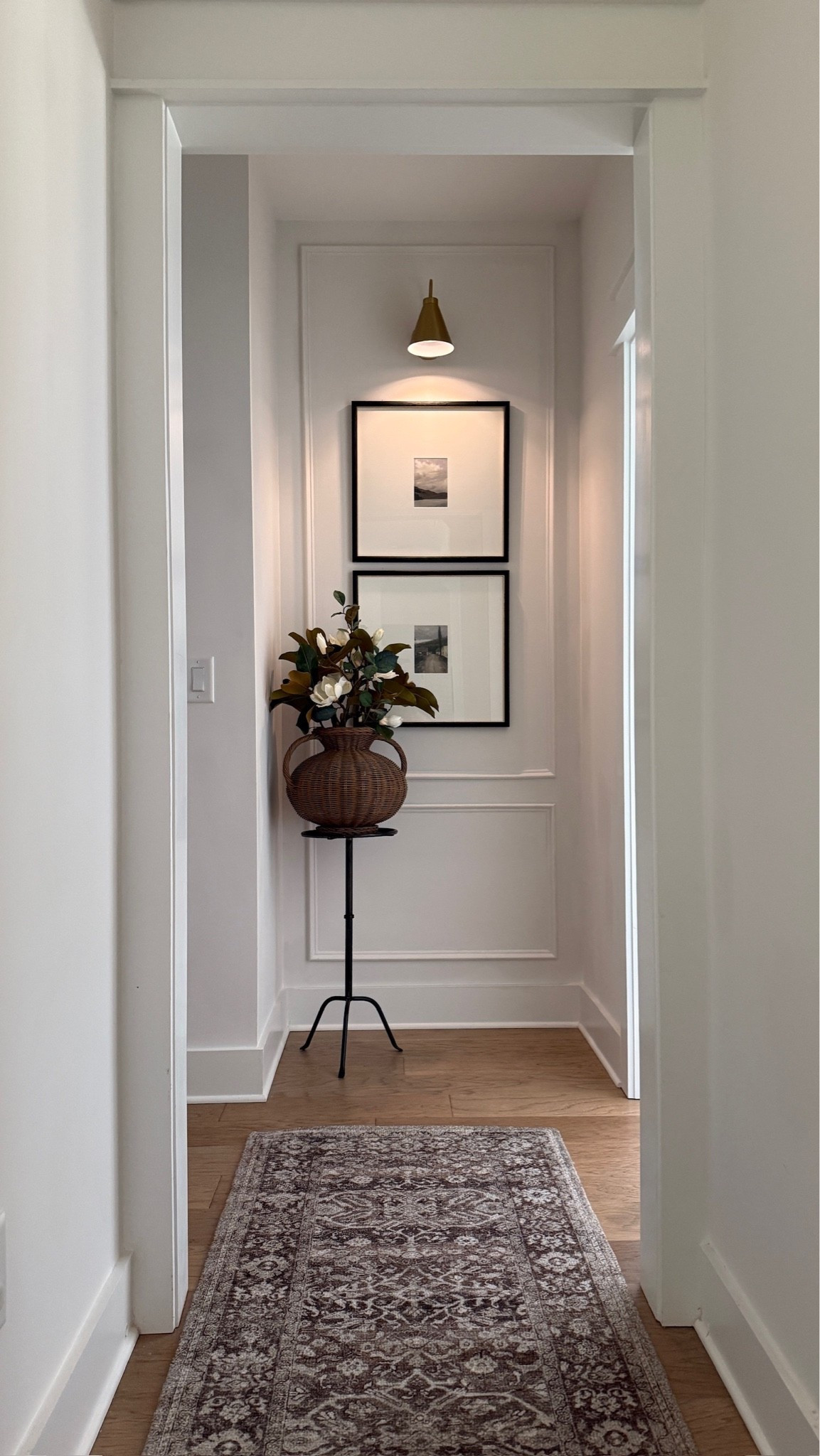 Simple and charming hallway styling! Love the mix of modern and vintage with runner, metal side table, woven vase, and my favorite wall frames. An elevated moment!

#LTKHome