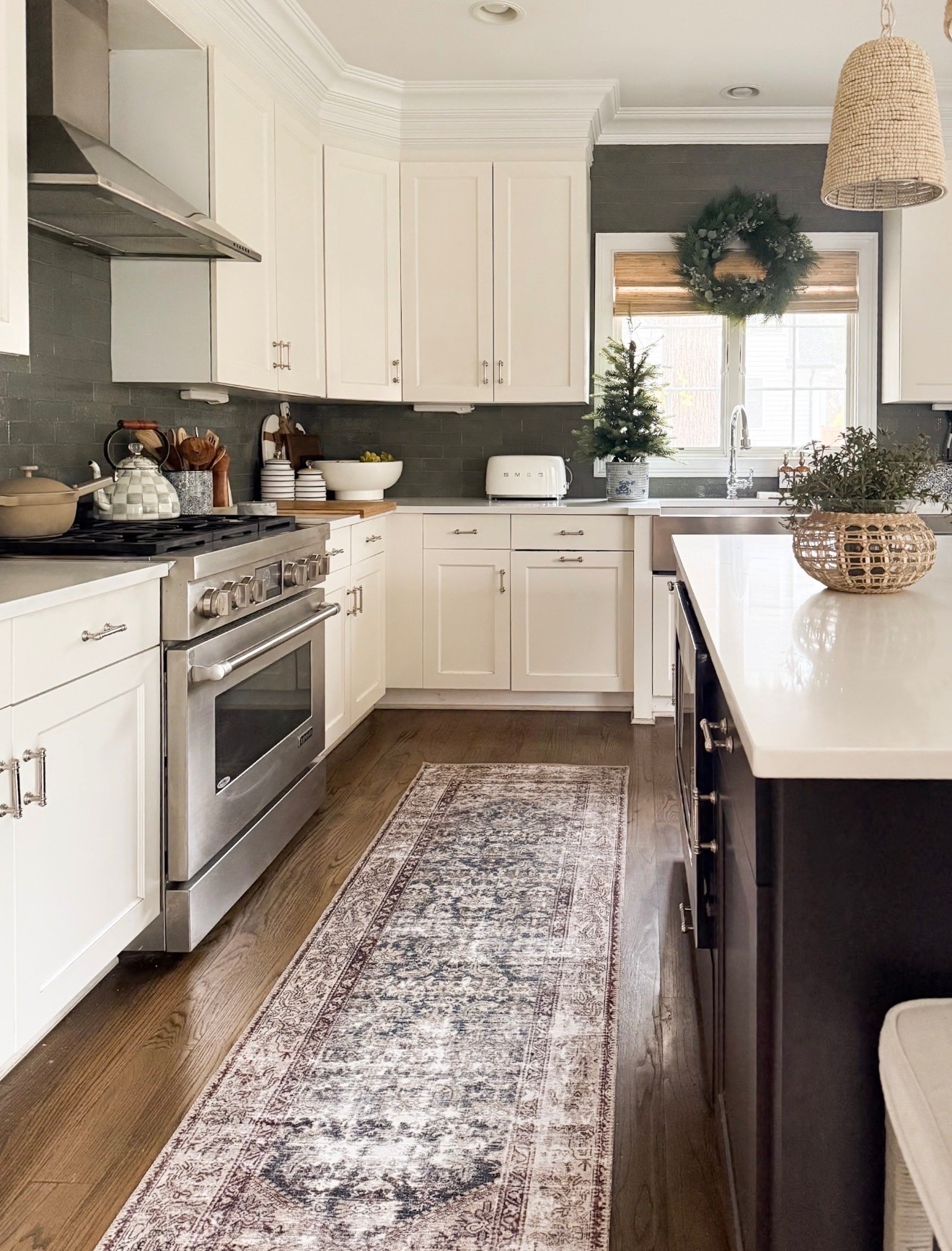 A runner rug is one of my favorite ways to make a kitchen feel warmer and more layered. The vintage inspired pattern breaks up the white cabinetry beautifully, while the muted tones complement the dark wood floors without making a busy space feel too busy.

kitchen runner rug, vintage inspired runner, neutral kitchen rug, patterned runner rug, traditional kitchen decor, washable kitchen rug, warm kitchen design, white kitchen inspiration, vintage style rug, kitchen decor ideas, girlonthehudson

#LTKHome #LTKfoodie