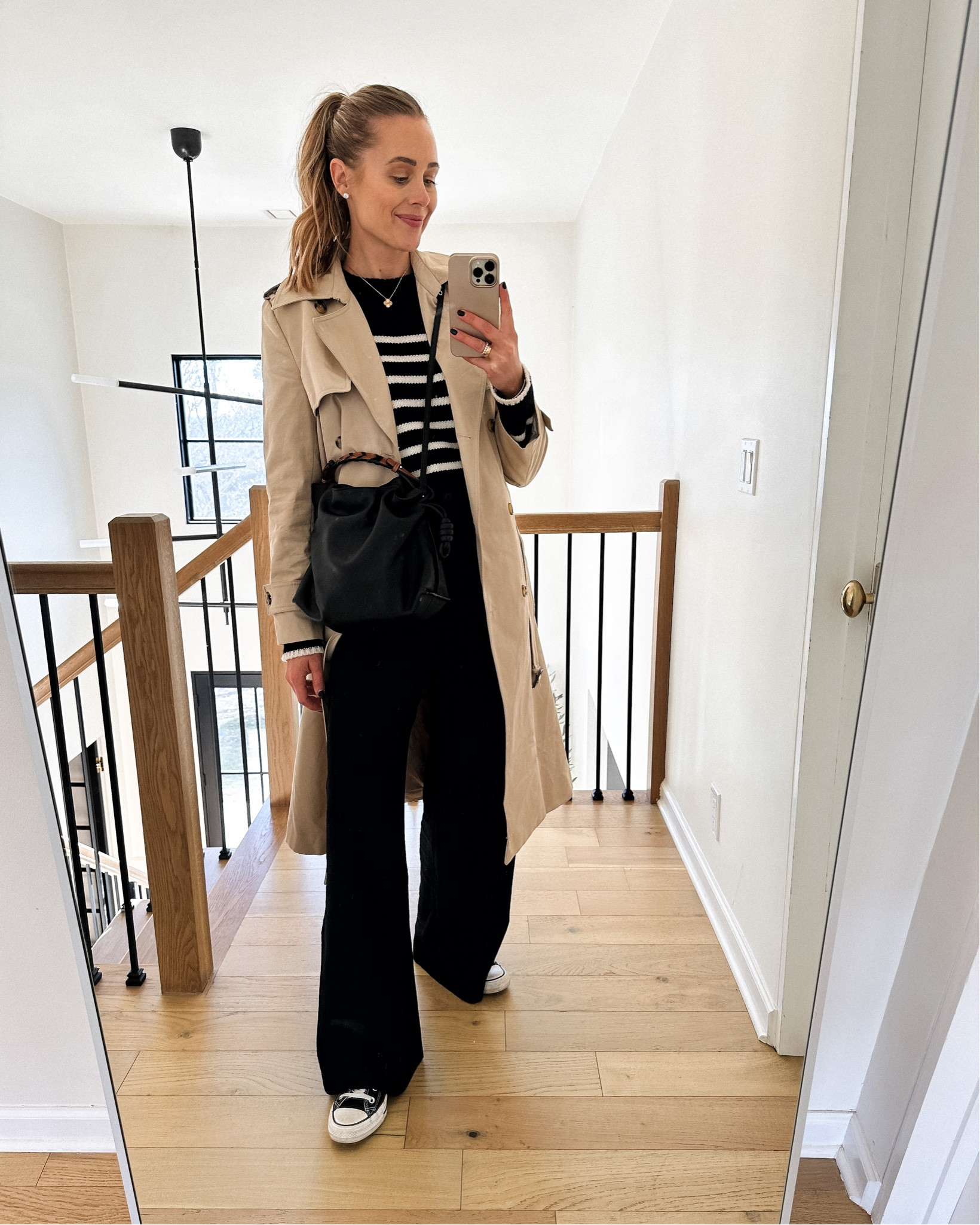 Fashion Jackson wearing trench coat outfit, striped sweater, black trousers, black converse sneakers, travel outfit, spring outfit #fashionjackson #trench #sneakers #nashvilleoutfits 

#LTKshoecrush #LTKstyletip #LTKunder100