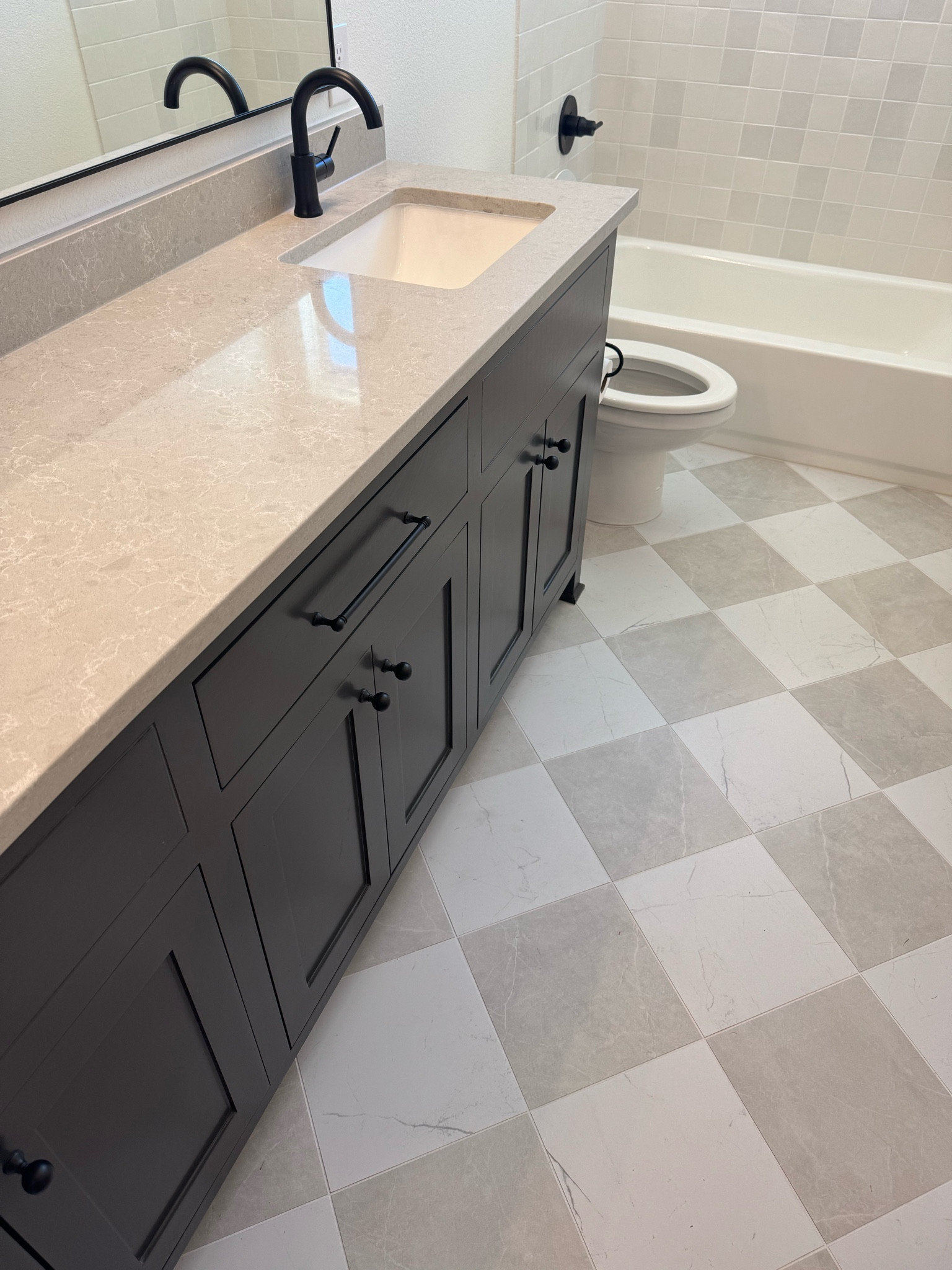 Checkerboard tiles are a vibe, trend or not. 

I’m obsessed with this bathroom… and let me just say, I went through so many tiles to find the perfect muted neutrals. These are the 12x12 silver and white , but keep in mind —- they’re almost always sold out or back ordered in this size. I tagged Wayfair but they are almost always sold out in 12x12 size . You can get on Emser website if in stock! 

If you want links to every design material in my house along with other details like grout colors, tips for installation, cabinet and custom built in measurements, wood stains and paint colors, my floor plan and more, check out my design PDF on my Instagram. 

 #checkerboardtiles

#LTKHome