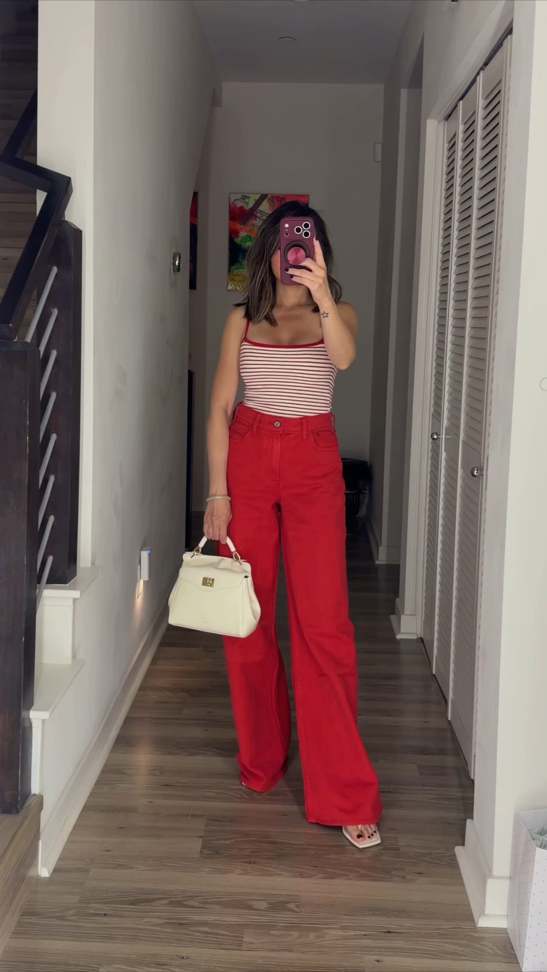 Memorial Day outfit ‼️ Loving these red wide leg jeans. They’re so comfortable and soft. Styled with a red stripe tank top that has a built in bra. My purse is also on sale—I’ve been eyeing it for awhile. Has a crossbody strap that’s convenient while you’re traveling. Comes in a ton of colors. Grab the full look on sale. 

Summer outfit, jeans, tank top, casual outfit, top handle bag, Abercrombie, The Stylizt