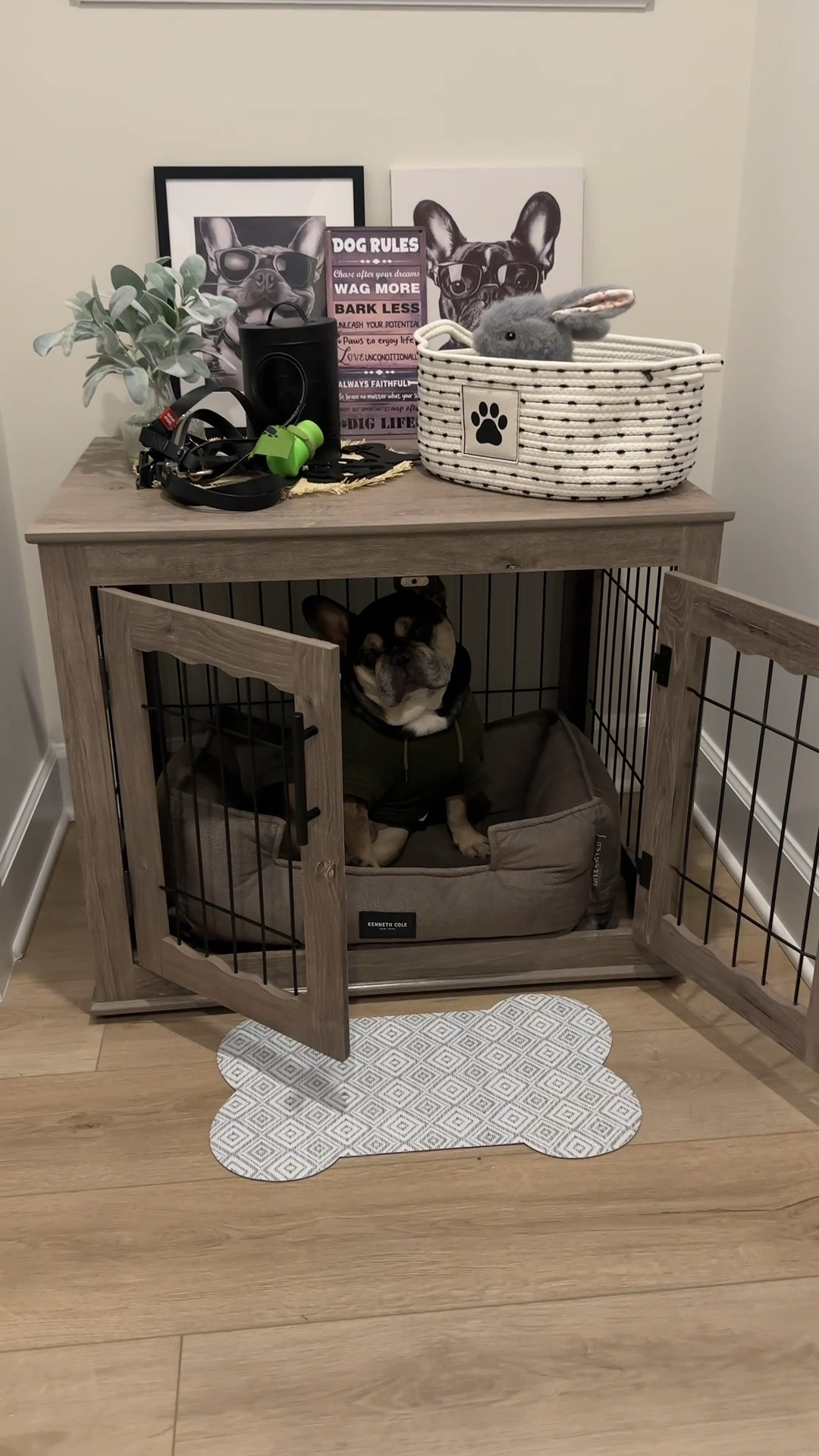 Deuce’s dog cave upgrade is officially complete 🐶✨ If you’ve been looking for a dog crate furniture piece that actually blends into your home decor, this is it. This wooden dog crate doubles as a side table/end table and looks like real furniture while still being a cozy dog crate for your pup.

I styled the top with French bulldog decor, a modern dog treat container, and a woven toy storage basket to keep everything organized but still aesthetic. I also added a small welcome mat in front to make his dog space feel like his own little room.

If you’re creating a dog corner, dog crate setup, or a stylish pet area in your home, this is such a good way to elevate it without it looking like a traditional kennel.

Linking the dog crate furniture, dog decor, dog storage, and pet organization finds I could find here 🖤

#dogcratefurniture #dogcavedecor #petcornerideas #frenchbulldoglife #dogmomlife #homepetsetup #dogroomdecor #petorganization #dogcrateideas #modernhomefinds #amazonhomefinds #dogspace #petfriendlyhome #homedecorinspo #ltkhome