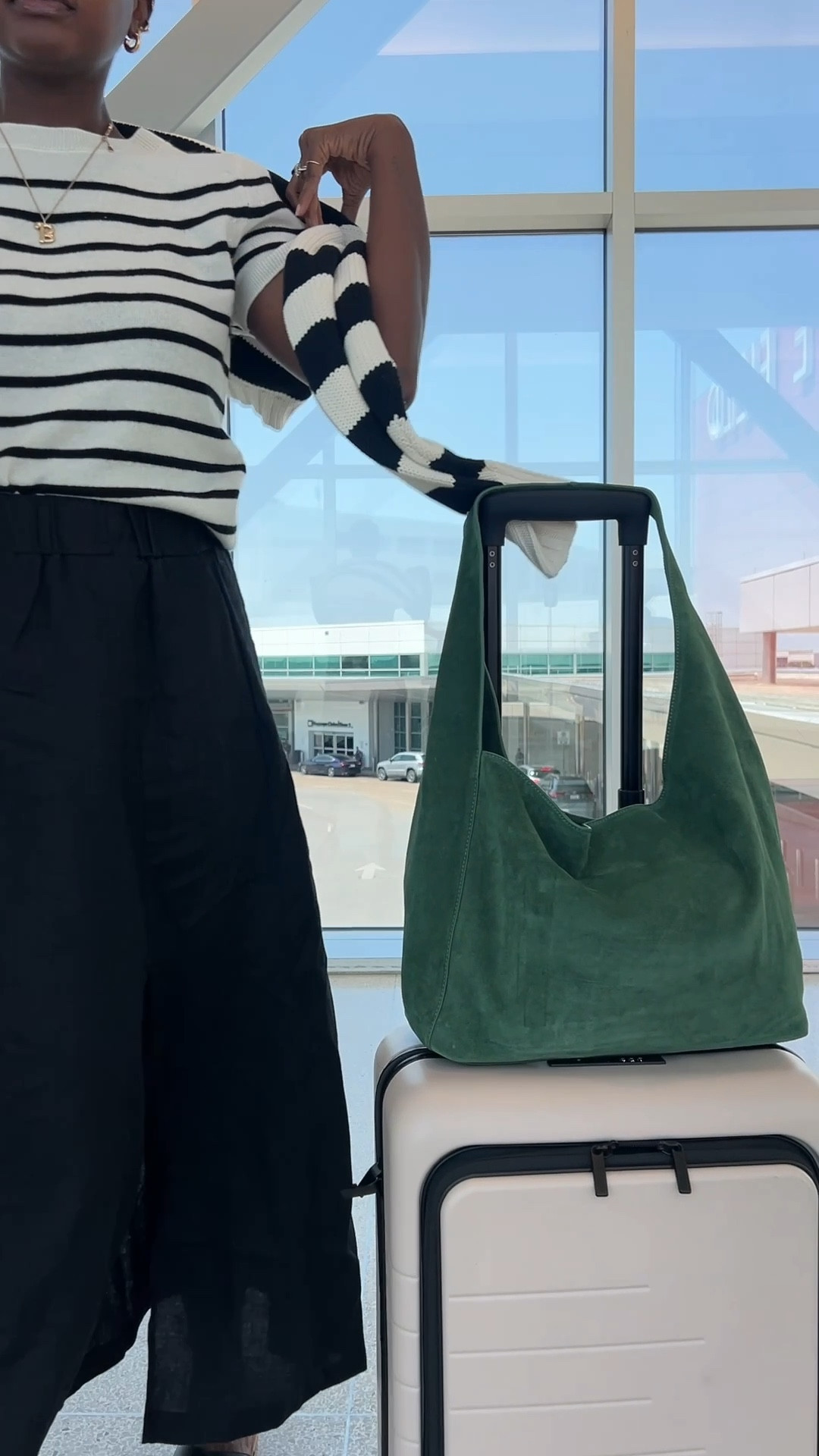 Elevated chic travel outfit from Quince! Black linen maxi skirt with side split, striped cashmere top, green suede purse, black leather sandals, striped knit polo sweater and olive oval sunglasses. 

#LTKFindsUnder100 #LTKTravel #LTKCon