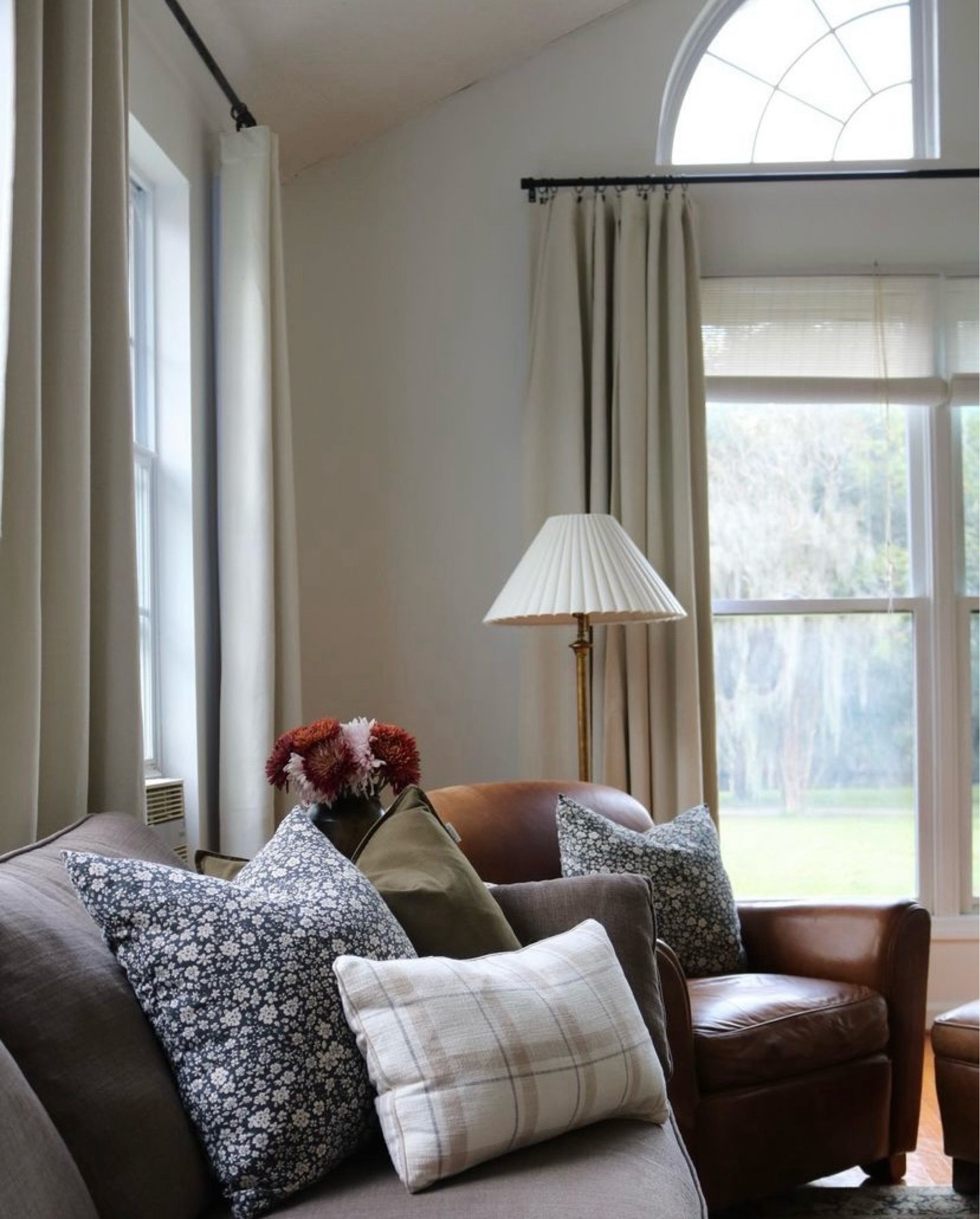IG: thekimmycox 
Warm neutral interiors, home decor, cozy living room, gray couch, leather chair, patterned pillows, pleated lamp, blackout curtains