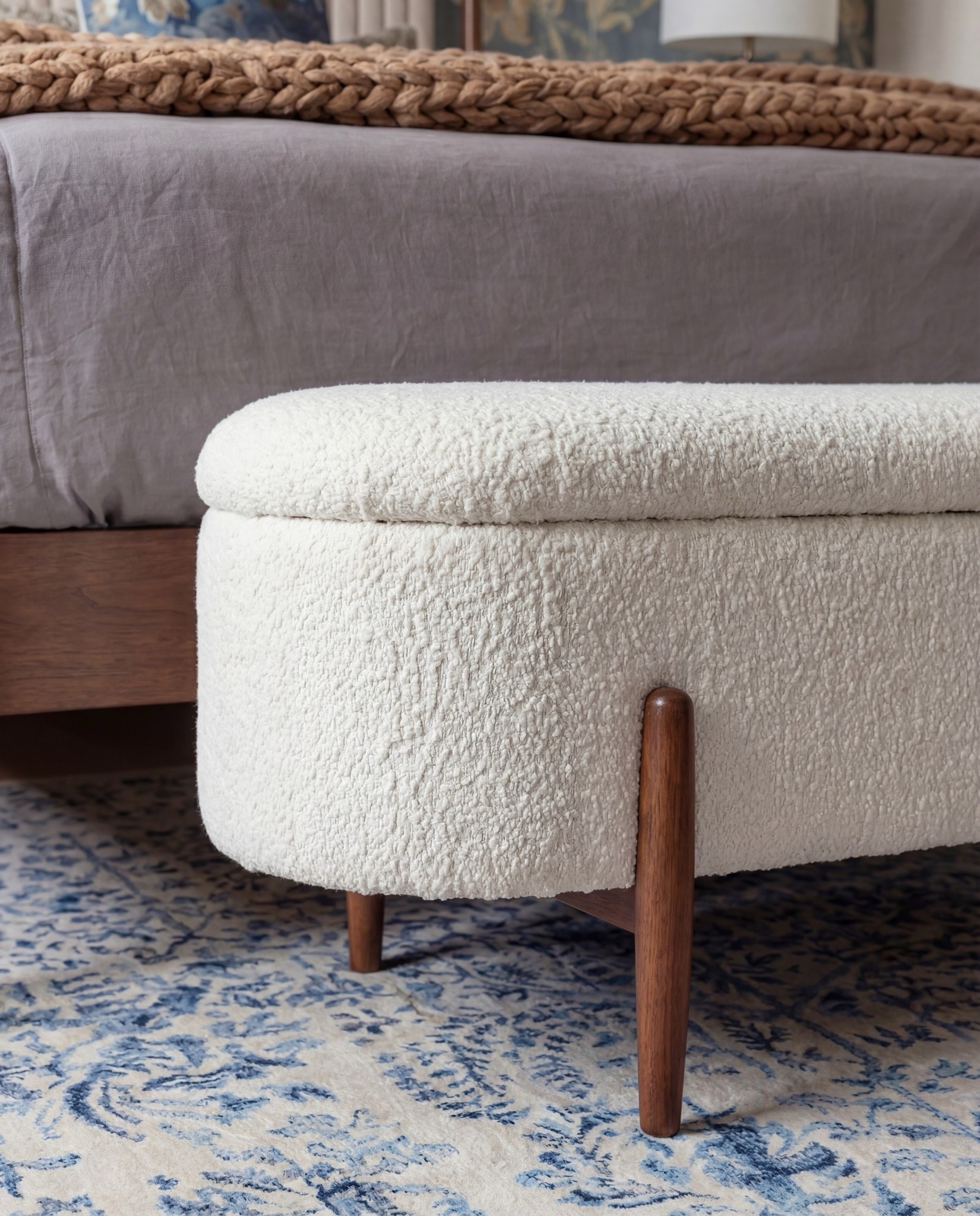 Shop the Look: Bedroom Refresh
• Warm-wood platform bed frame
• Vertical-channel upholstered headboard
• Gray duvet cover + layered sheet set
• Mixed blue + neutral accent pillows
• Oversized chunky knit throw blanket
• Shearling-style upholstered storage bench at the foot of the bed
• Pair of dark-wood campaign-style nightstands with brass hardware
• White drum-shade table lamps with blue glass bases
• Blue decorative bowls
• Bead garland décor
• Stack of books (nightstand styling)
• Framed oversized floral artwork above the bed
• Blue floral wallpaper (full wall + ceiling)
• Exposed wood ceiling beams
• Blue patterned area rug
• Window bench with plaid/tan accent pillows

#LTKSpringSale #LTKHome #LTKSaleAlert