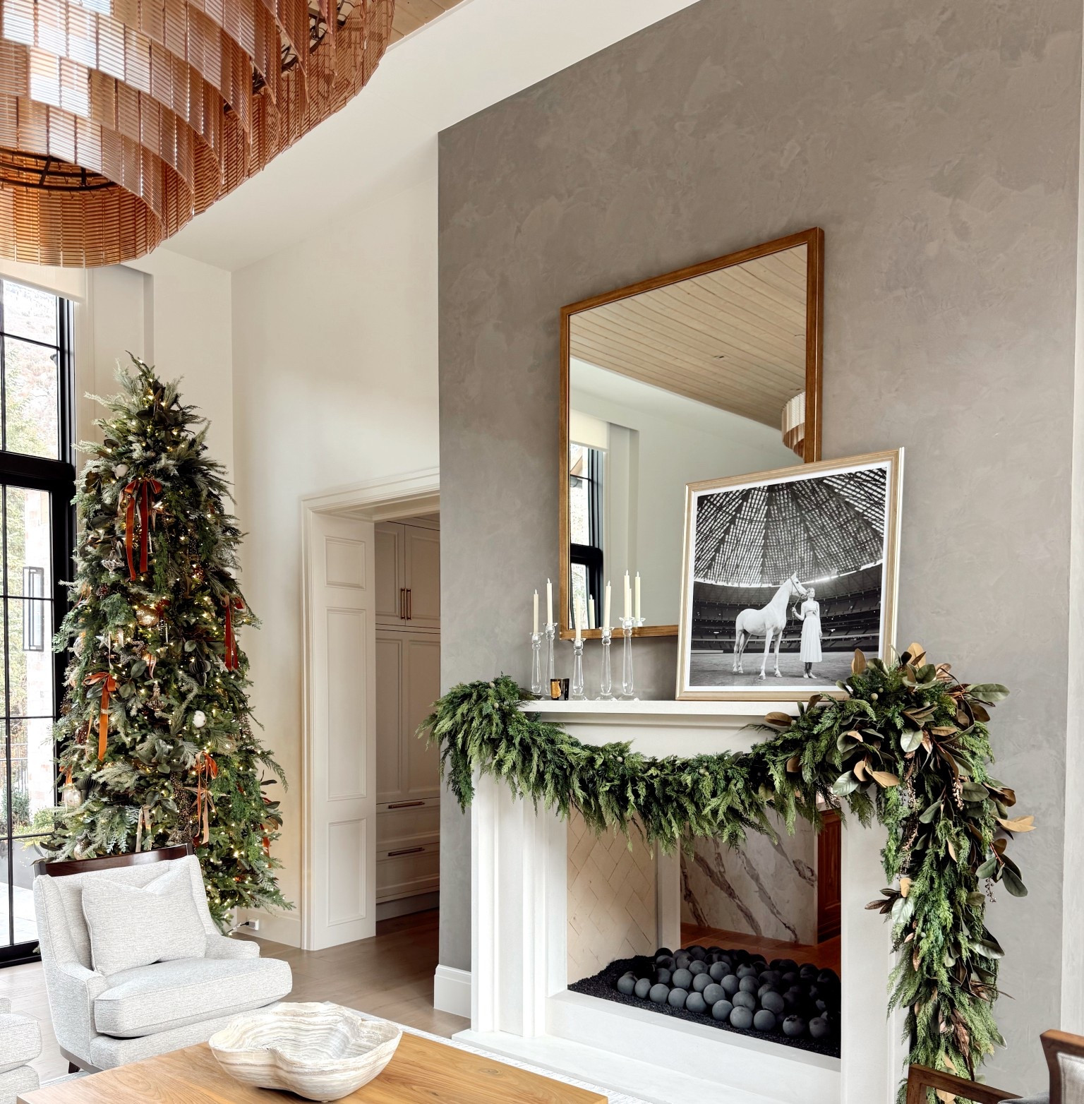 Client living room install ✨ Layers of fresh greenery, soft neutrals, and a hint of amber glow — a modern Christmas moment that feels both fresh and timeless. Such a fun project to bring to life! 🎄 #DeHartDesigns #HolidayHomeStyle 

#LTKHoliday #LTKSeasonal