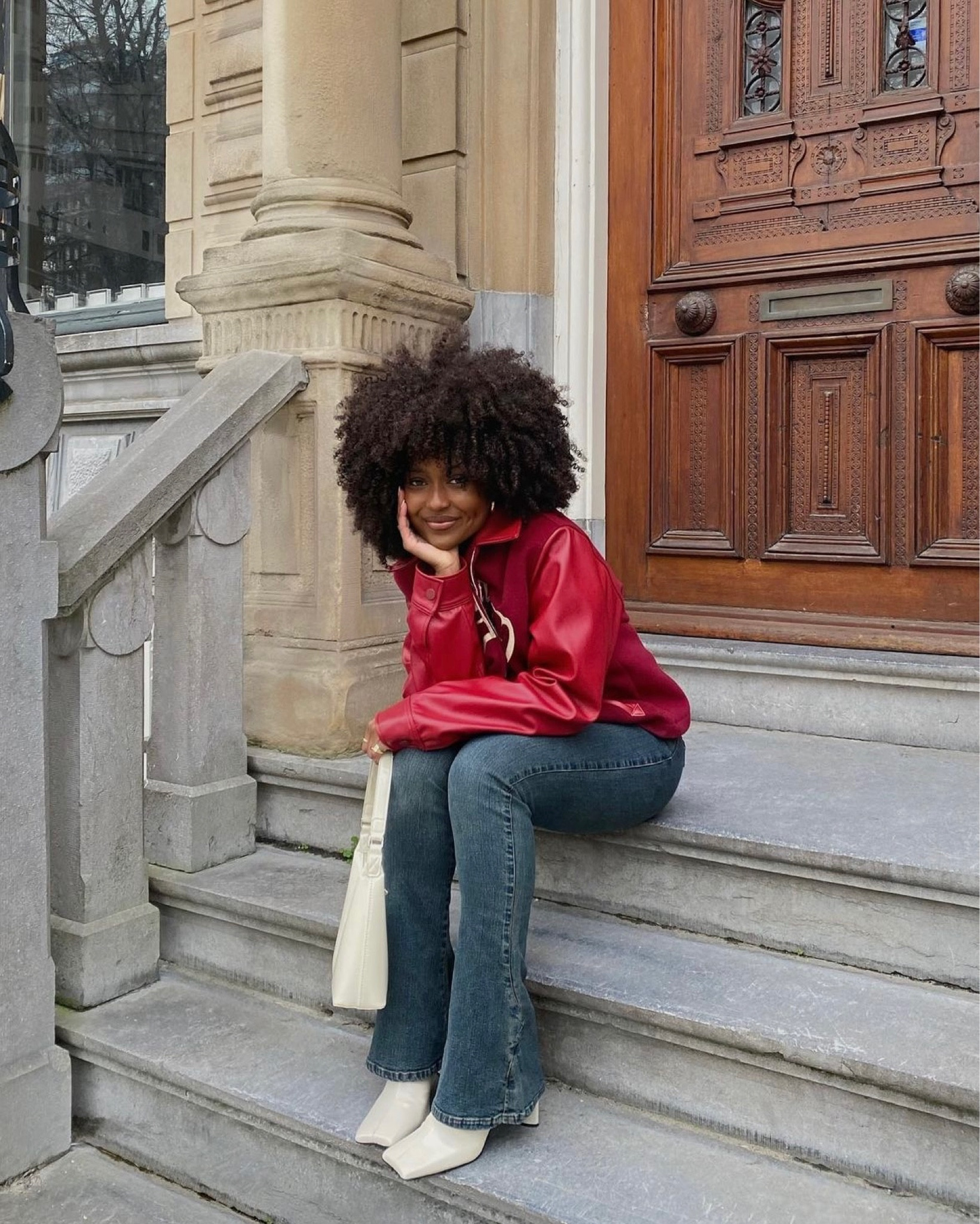 original bag is Glynit and jacket La Fam Amsterdam fall autumn outfit red leather jacket flare vintage jeans  cream beige white bag ankle heel boots  curly afro hair 

#LTKSeasonal #LTKeurope #LTKstyletip