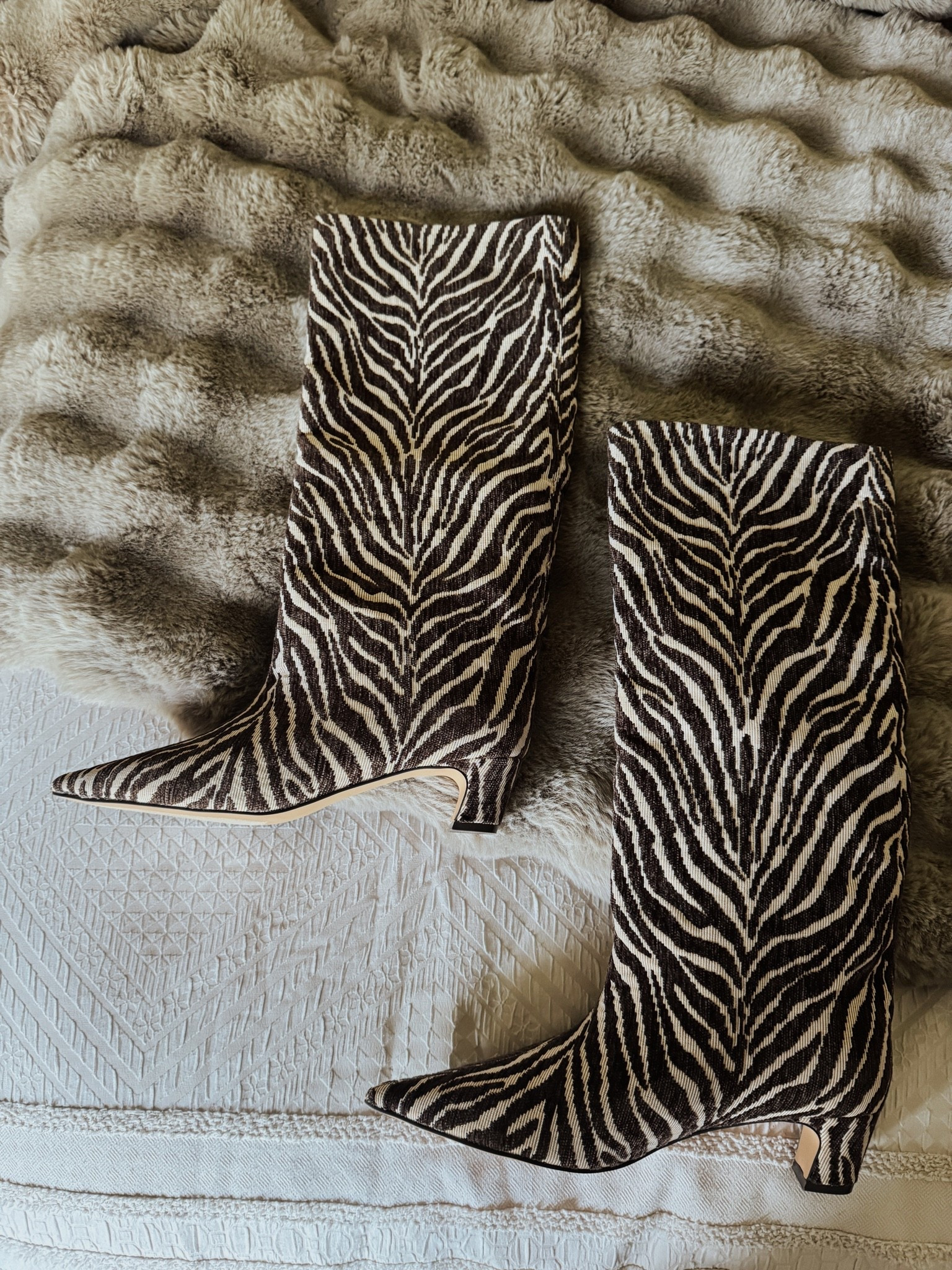 These boots have a great low heel and are made of a woven fabric, not leather. Fit is tts- I got 8.5.
