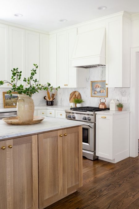 White and wood kitchen design with marble countertop and marble back splash. Vintage vase and faux green stems  

#LTKhome #LTKSeasonal