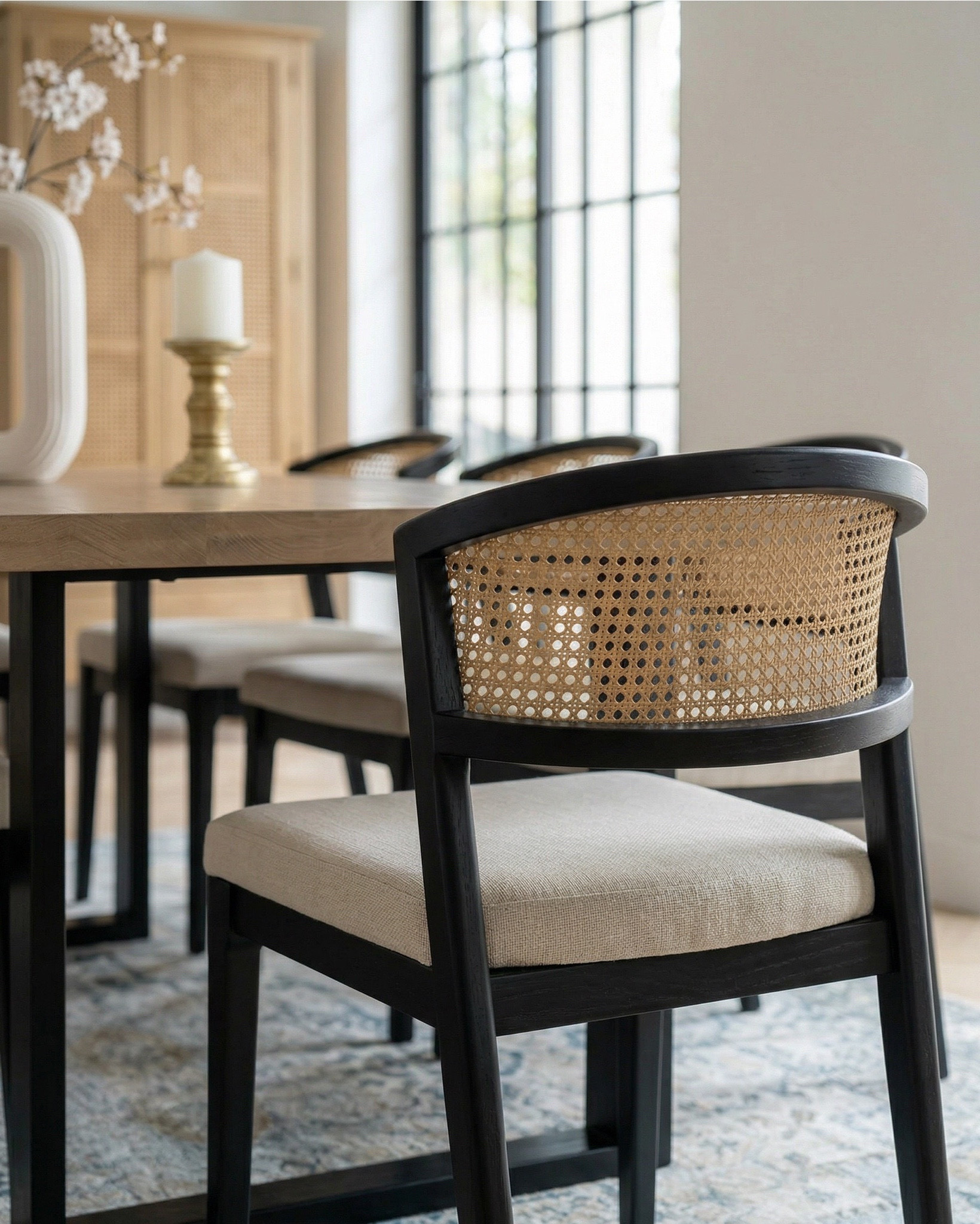 Shop the look: 
* Wood Dining Table
* Black upholstered dining  Chairs 
* Wood console table
* Brass table lamp 
* White ceramic vase
* Brass candle holders
* Blue wall art
* Neutral modern wall art
* Brass wall sconce 
* Wood cabinets 
* Blue traditional pattern rug
* Blue wall paper
* Tall ceramic vase
* Black decor bowl

#LTKhome #LTKsale #LTKstyletip