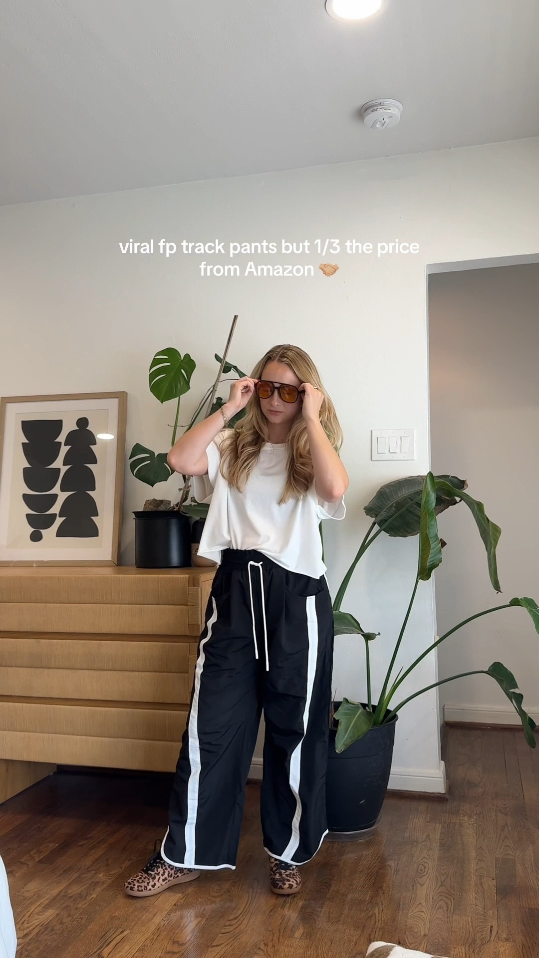 Styling trendy track pants for fall! Wearing M in pants (I’m 5’4) and S in open back tee. 

#LTKActive #LTKFindsUnder50 #LTKStyleTip