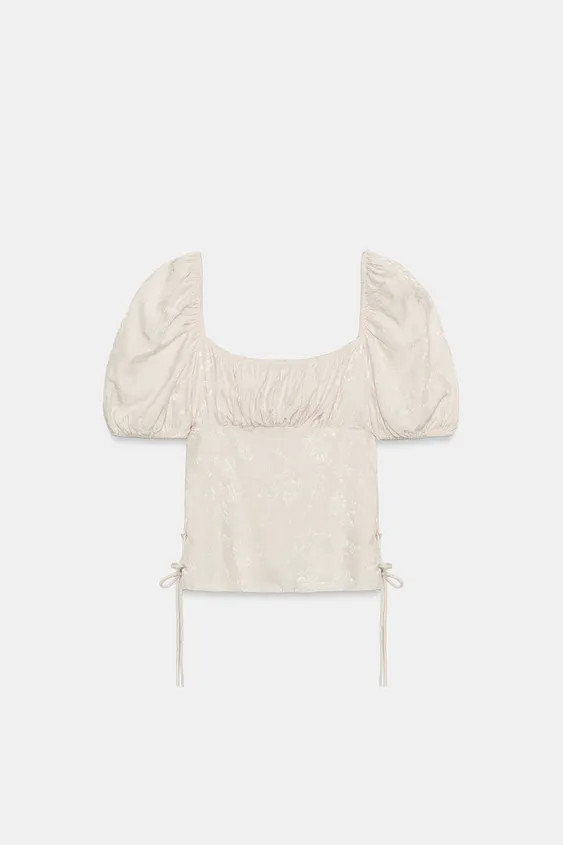 Square neck top with short elasticized sleeves. Features draped fabric detail and side tie-up det... | Zara US
