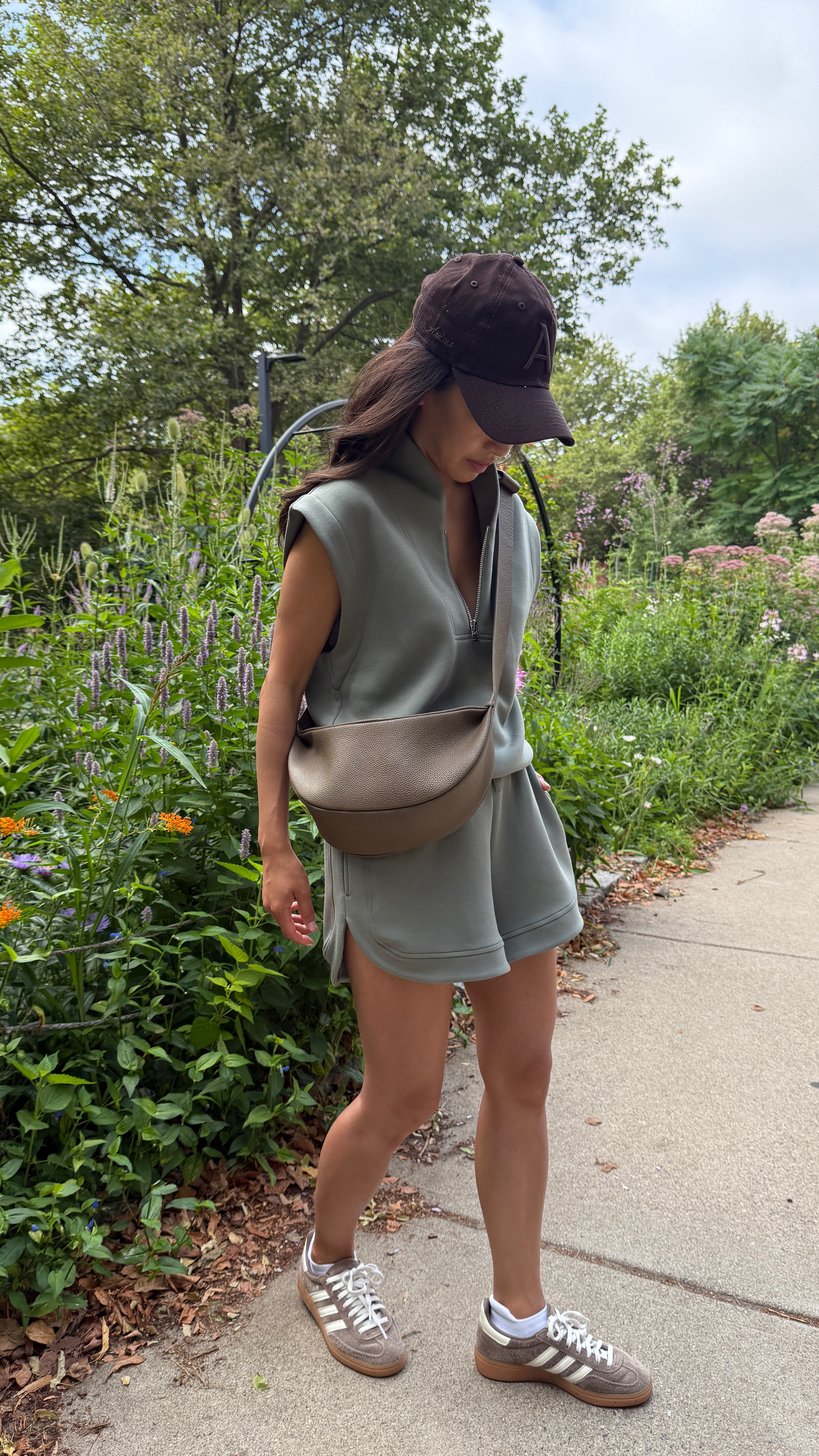 Comfy sneakers, sling bag + petite friendly athleisure set. super soft, easy to throw on and always gets compliments!

• Amazon crossbody sling bag, high quality pebbled leather and holds a good amount. Look for less for COS which is much pricier.

• adidas handball sneakers - comfy and supportive for me, def more than sambas or gazelle. 

I’m usually a women’s 5/5.5 in other brands and the Big Kids size 3.5 linked fits me best, like women’s 5-5.5. Big kids sizing in that color is fully stocked at Nordstrom.

• Varley Loretta half-zip cap sleeve top xxs

•Varley Ollie high-rise short 3.5” inseam xxs

• Neiwai bra Xs/s a super comfy everyday favorite

• Aritzia baseball cap, linked a polo hat, which I like the fit of more 

Casual athleisure outfits,  travel outfit, busy mom style, athleisure set

#LTKActive #LTKPetite #LTKTravel