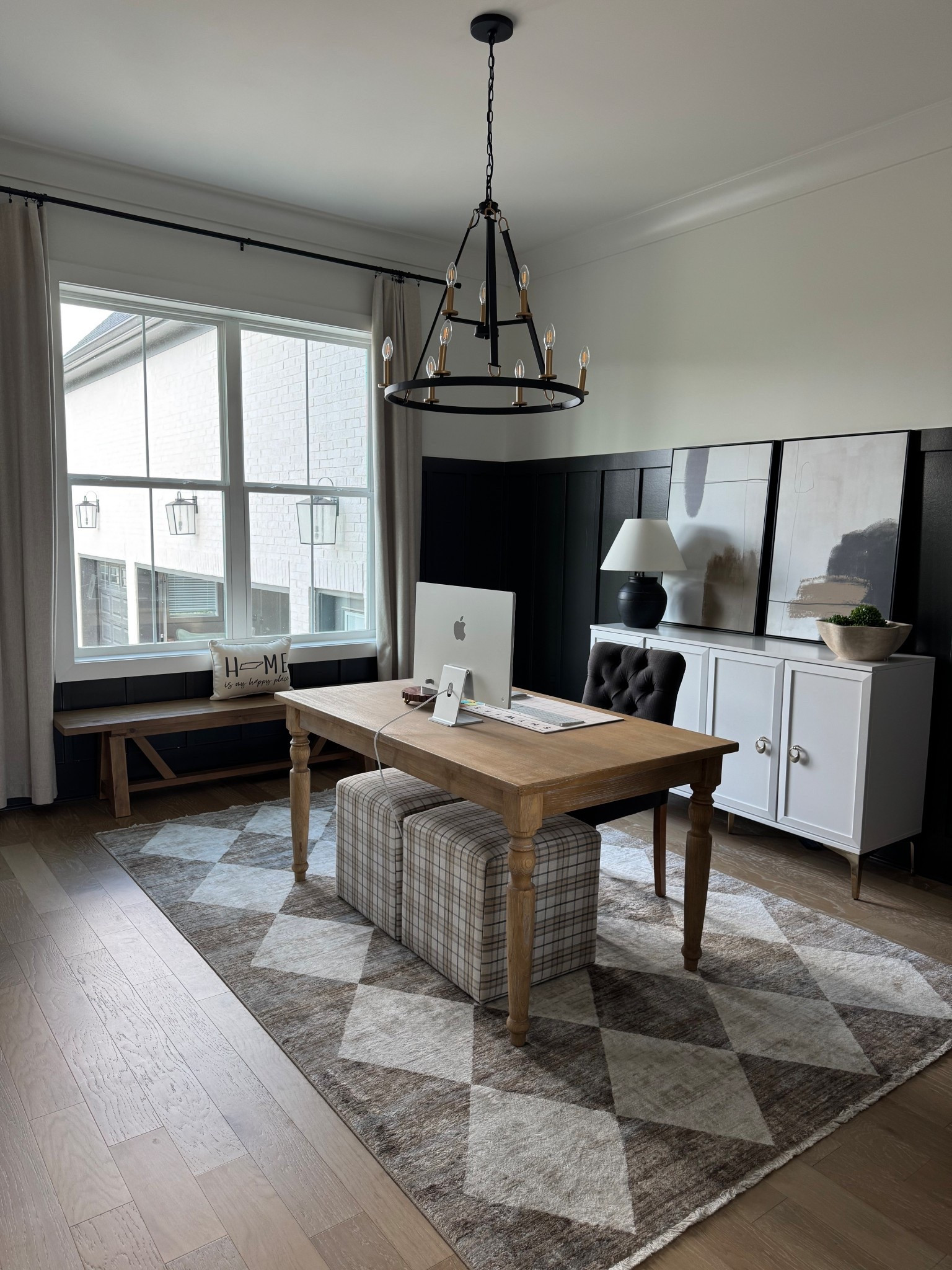 Neutral modern home office with cozy, moody decor.  This space features my favorite budget-friendly living room rug that also works perfectly in a home office. Checkered Fringed Rug from Rugs USA, paired with a solid wood farmhouse desk, upholstered plaid ottomans, blackout curtains, and a large black ceramic table lamp, it blends modern farmhouse and contemporary style seamlessly. The diamond patterned rug is soft, easy to clean, and the perfect neutral for any room.

Shop exact pieces from my office:
–  Checkered Fringed Rug – Rugs USA
– Grain Wood Furniture Valerie Pine Solid Desk – Wayfair
– Lynwood Square Upholstered Cube Ottoman – Target
– Large Ceramic Table Lamp – Target
– Leona Wood Farmhouse Bench – World Market
– INOVADAY Blackout Curtains – Amazon

#NeutralHomeDecor #LivingRoomRug #HomeOfficeDecor #ModernFarmhouse #TransitionalStyle #BudgetHomeDecor #RugLove #HomeDecorIdeas

#LTKHome
