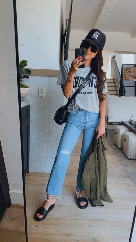 Casual everyday denim, graphic tee, comfy slides and baseball cap 