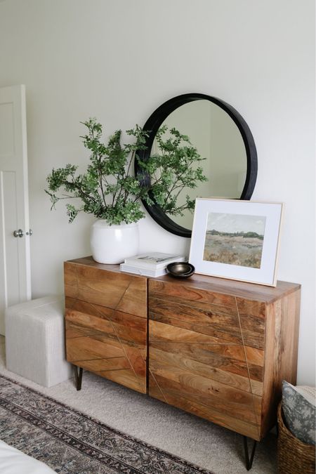 In our primary bedroom we have a West Elm wood dresser, Target square upholstered ottoman, Pottery Barn faux stems, black round mirror  

#LTKstyletip #LTKhome #LTKFind