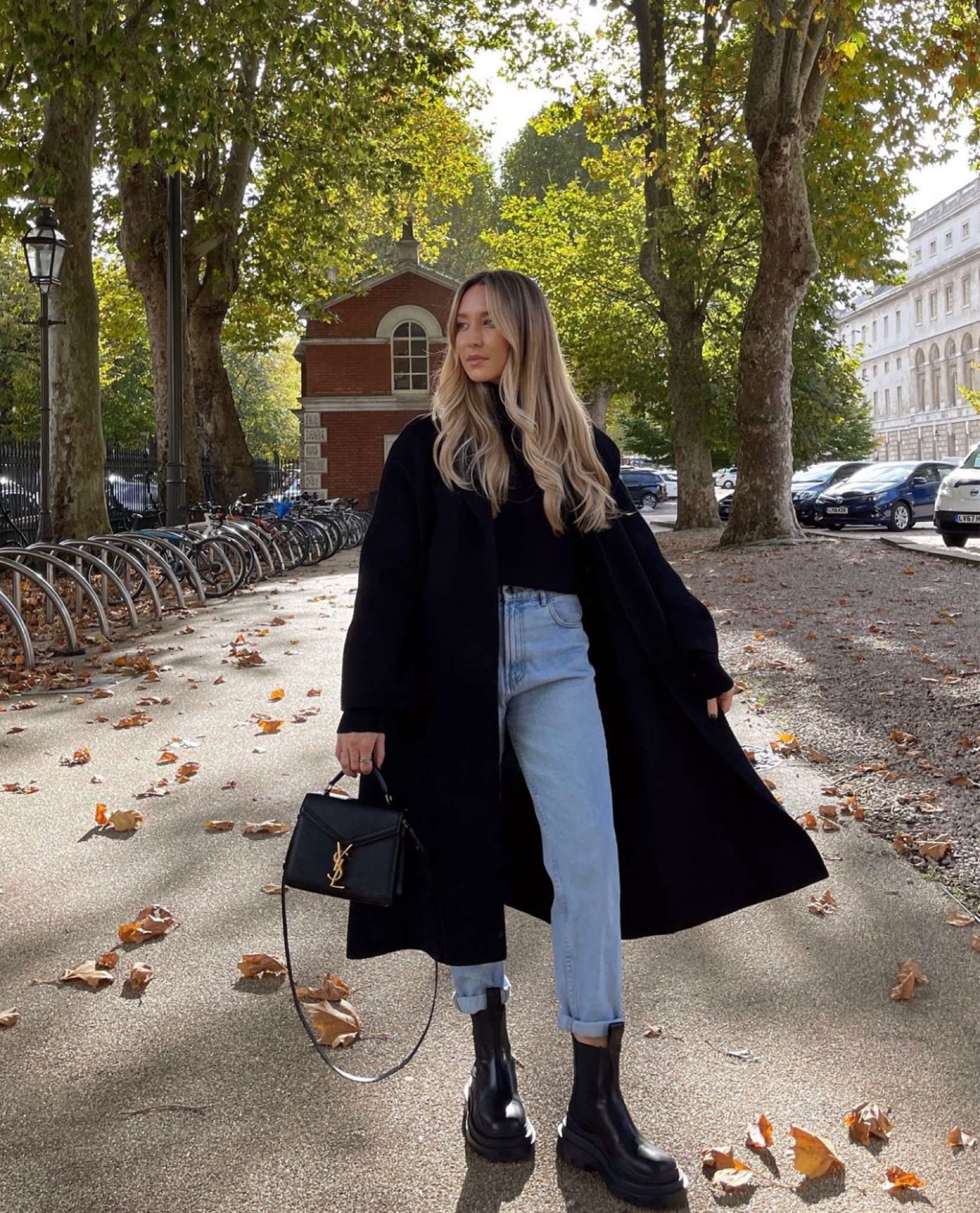 A black coat is the perfect dramatic piece for autumn - when it’s still warm enough you don’t need to wrap it up! Black chunky jumper with baggy blue jeans, chunky boots and YSL Cassandra mini

#LTKautumn