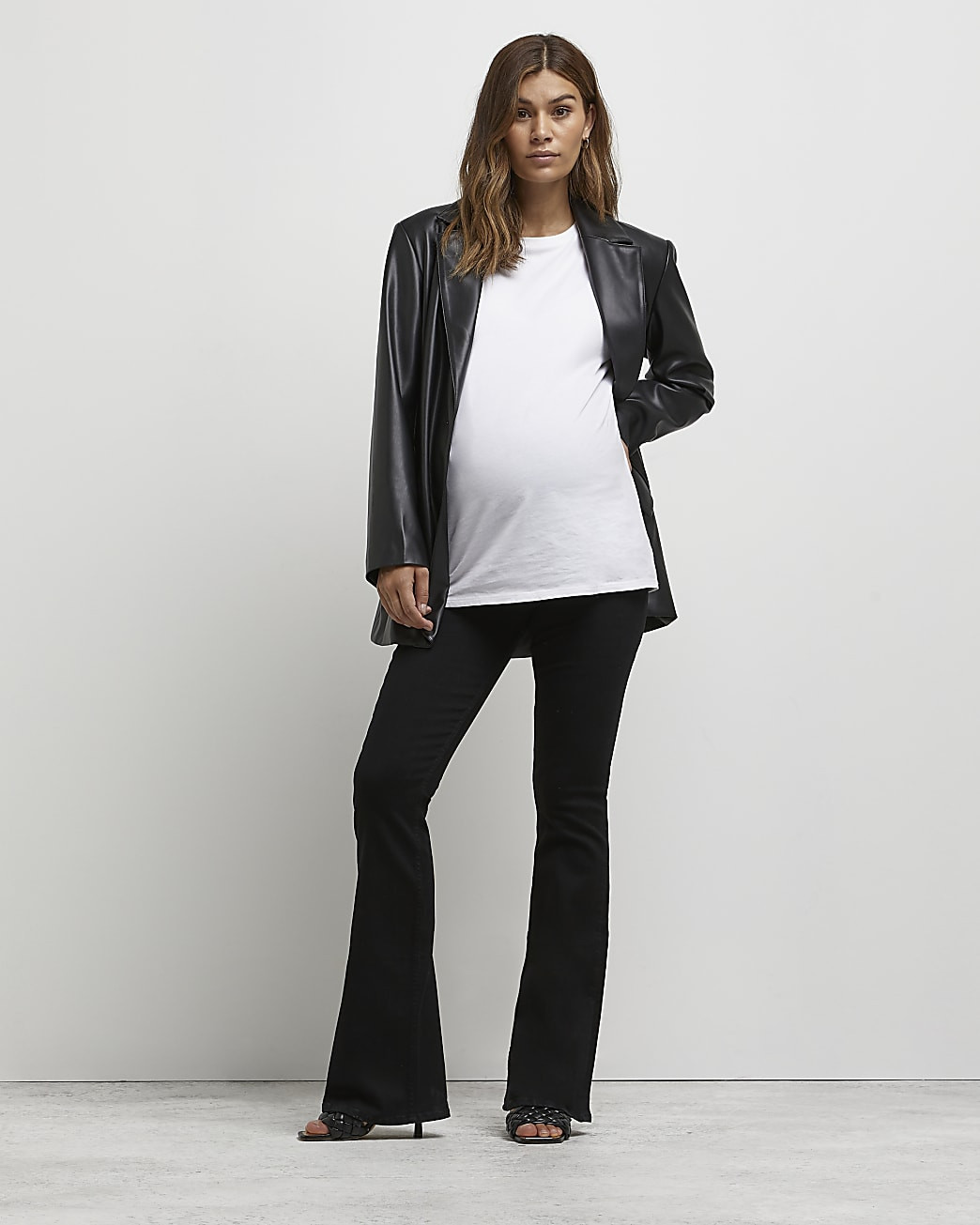 Black mid rise maternity flared jeans | River Island (UK & IE)