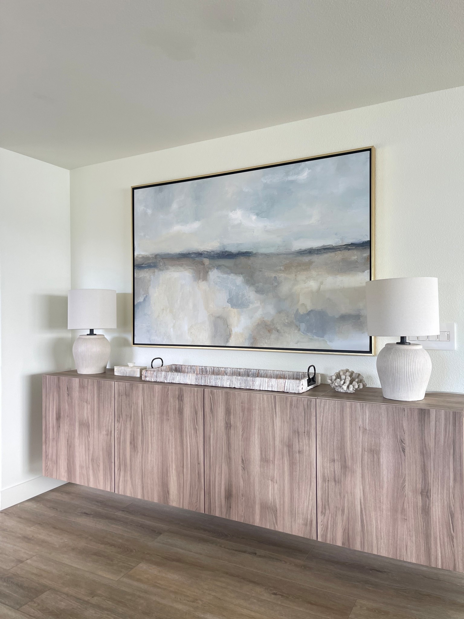 Entryway cabinets, affordable lamps, whitewash tray and oversized 40” x 60” coastal artwork with gold frame. Cabinets are IKEA Besta wall mounted.

#LTKHome