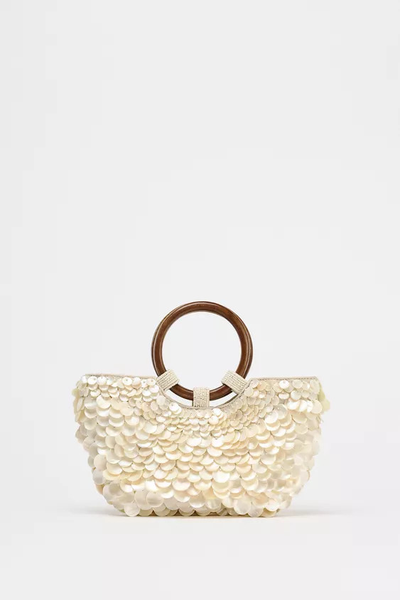 Half-moon shaped bag with faux mother-of-pearl appliqués. Double circular top handles and a remo... | Zara US
