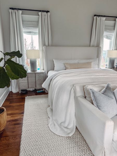 Neutral primary bedroom suite. White bedding on Eastern King bed and braided off-white rug. Pottery Barn Teen drapes and Sherwin Williams paint  

#LTKsalealert #LTKSeasonal #LTKhome