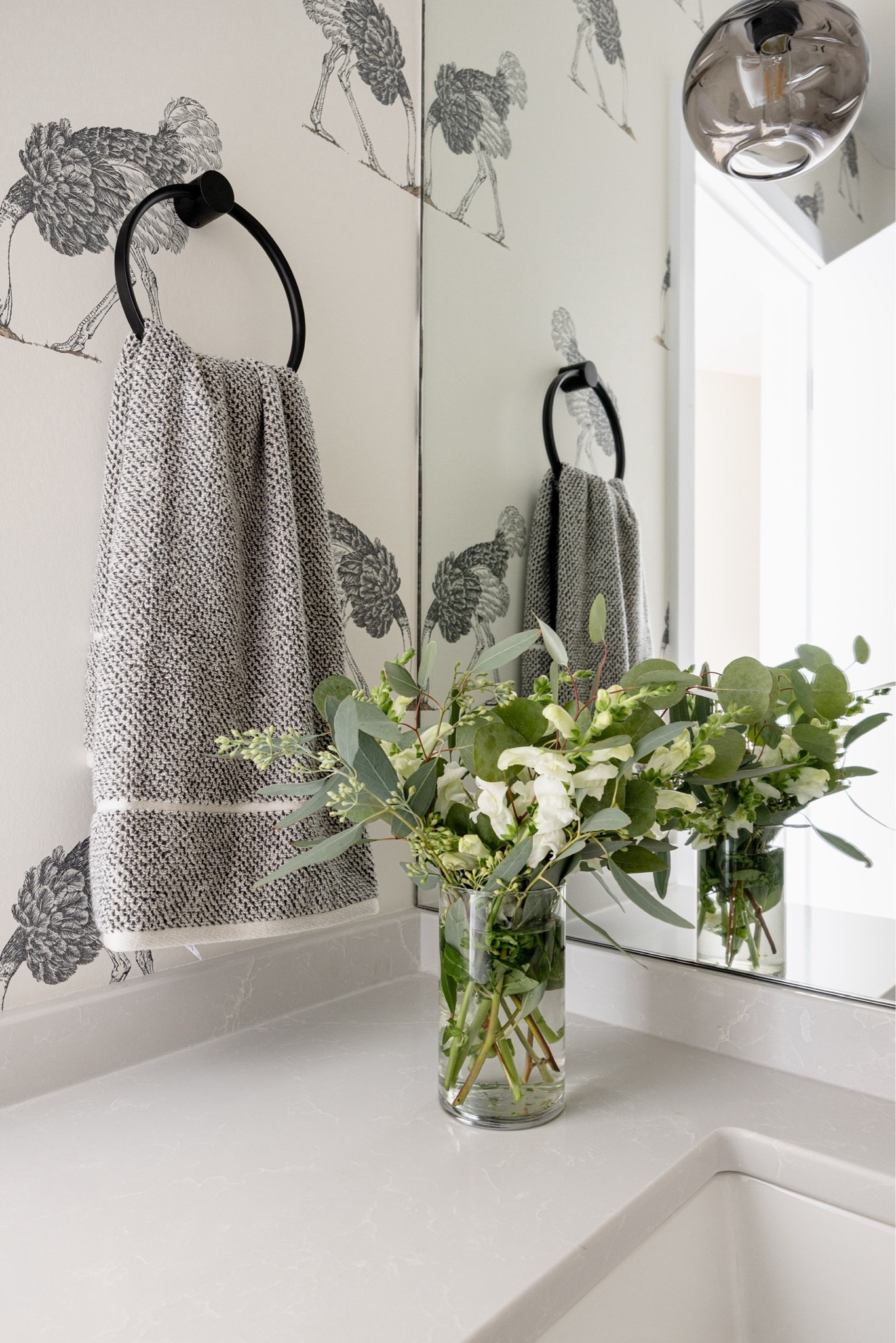 Simple and modern half bath decor. A matte black towel ring, heathered hand towels in charcoal, and a faux flower arrangement for the perfect finishing touch. Scenes from our Sunfish Lake powder bath remodel. 🤍

#LTKHome