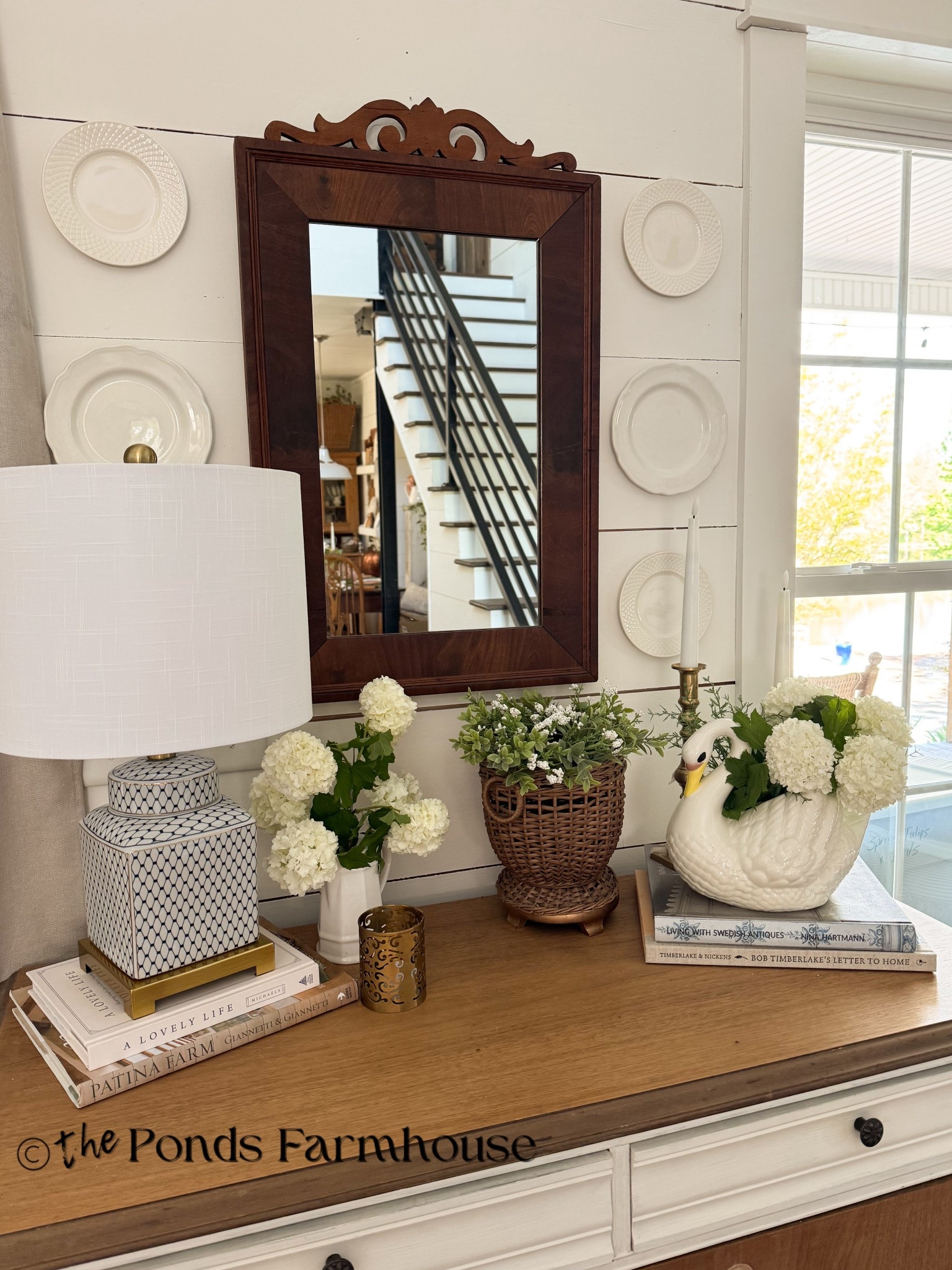 Entry table with vintage mirror, swan, & ironstone.  

#LTKSeasonal #LTKHome