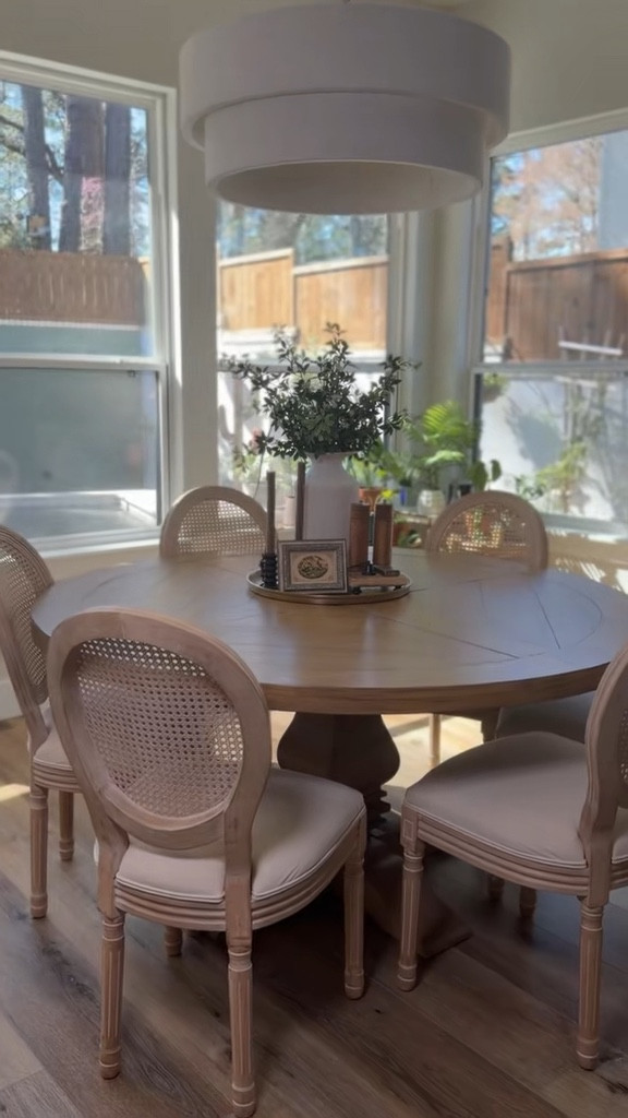 Elevated neutral dining space featuring a round wood pedestal table with a subtle plank detail and matching cane back dining chairs l love how the light wood tones keep the space feeling warm and organic while the woven rattan texture adds that timeless European-inspired charm.
#LTKOver40 #LTKHome
#LTKSeasonal

#LTKHome