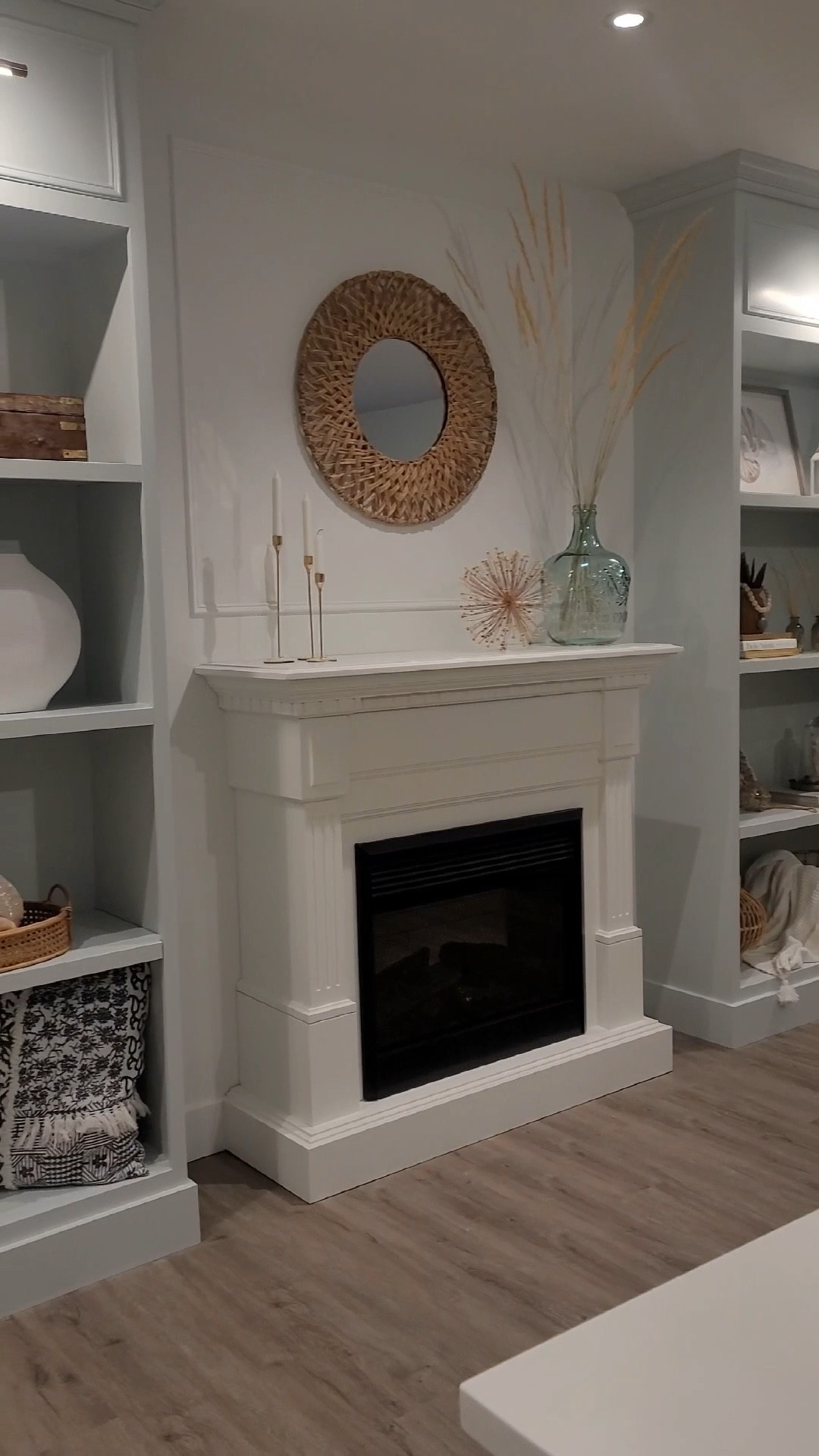 An airy and bright basement is a wonderful place to spend time in and relax. When we finished off this area I wanted a coastal, Hampton’s style elegant yet casual vibe and we achieved with a light blue, white and tan color scheme. Paired together with library lighting over tall display shelves and an electric fireplace to bring warmth and coziness. It all came together and it is a fabulous area to hang out in.

#LTKHome #LTKFindsUnder100 #LTKFindsUnder50