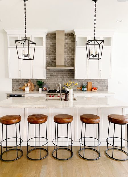 Utilizing leather barstools with an airy black metal base help tie in the beautiful island pendant lights without blocking those woodwork details!
.
.
.
Leather Barstools 
Industrial 
Modern
Farmhouse 
Moody
Black Metal
White Cabinets
Black Cabinets

#LTKstyletip #LTKunder100 #LTKhome