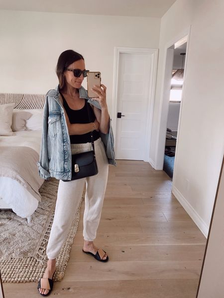 Elevated casual outfit from April’s capsule wardrobe 
Sweatpants- tts but if between size down 
Oversized denim jacket 
Fitted ribbed tank- tts 
ITSYBITSYINDULGENCES10 for 10% off sandals 

#LTKstyletip #LTKsalealert