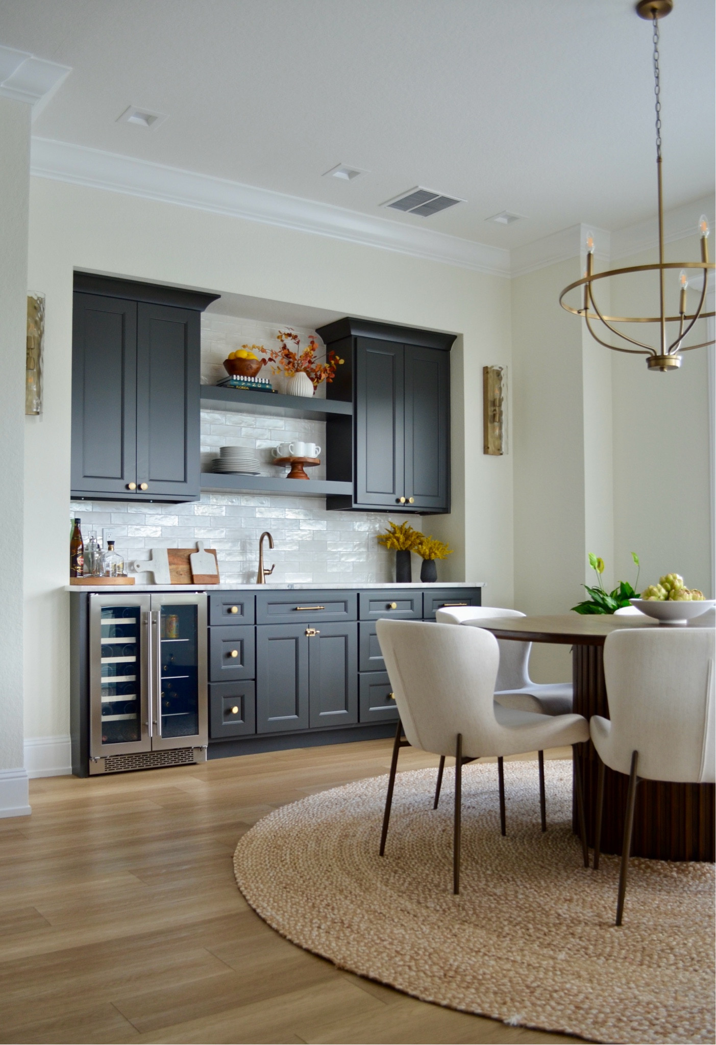 Wet bar/dry bar views 

Jute rug, chandelier, dining table, round table, dining chair, kitchen decor, mini refrigerator, light sconces  

#LTKhome