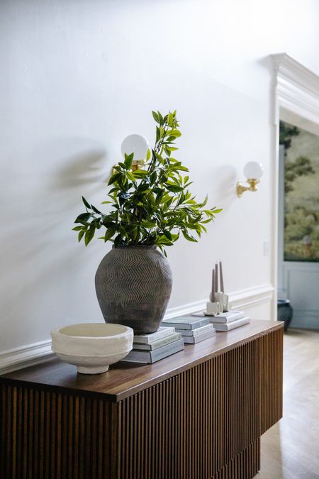 Transitioning your home to warmer weather can be as simple as rotating your coffee table books! Read all of my tips at ChrisLovesJulia.com today 🖤

Sideboard, vase, faux stems, paper mache bowl, candlestick

#LTKhome #LTKSeasonal #LTKstyletip