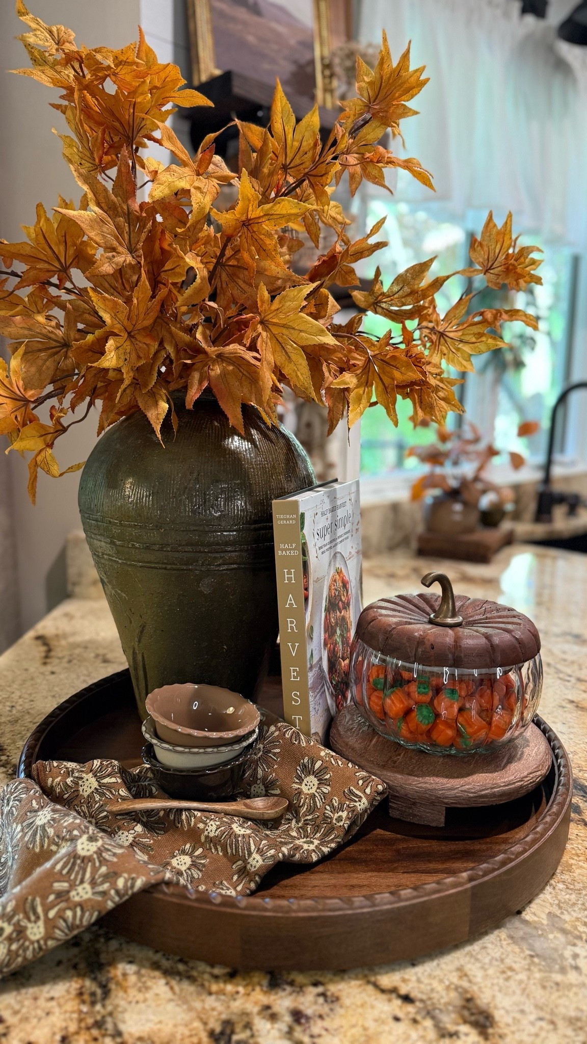 Timeless & Tasteful Fall Centerpiece
Follow @farmtotablecreations on Instagram for more inspiration.

Reference: 6 stems used in vase. 

This fall tray styling blends cozy charm with functional elegance. A large vintage ceramic vase is filled with golden autumn maple branches, paired with a wood-lidded glass pumpkin candy jar, a seasonal cookbook, and dainty fall bowls resting on a floral kitchen towel. The rich textures and warm tones create a welcoming focal point for your kitchen island or dining table—perfect for enjoying all season long.

#fallcenterpiece #falltraydecor #falldecor #kitchendecor #traydecor #ltkfall #centerpiecestyling #seasonaldecor #kitchenstyling #falldecorideas #autumnhomedecor #amazonhome #amazonfinds #amazon

#LTKSeasonal #LTKHome #LTKSaleAlert